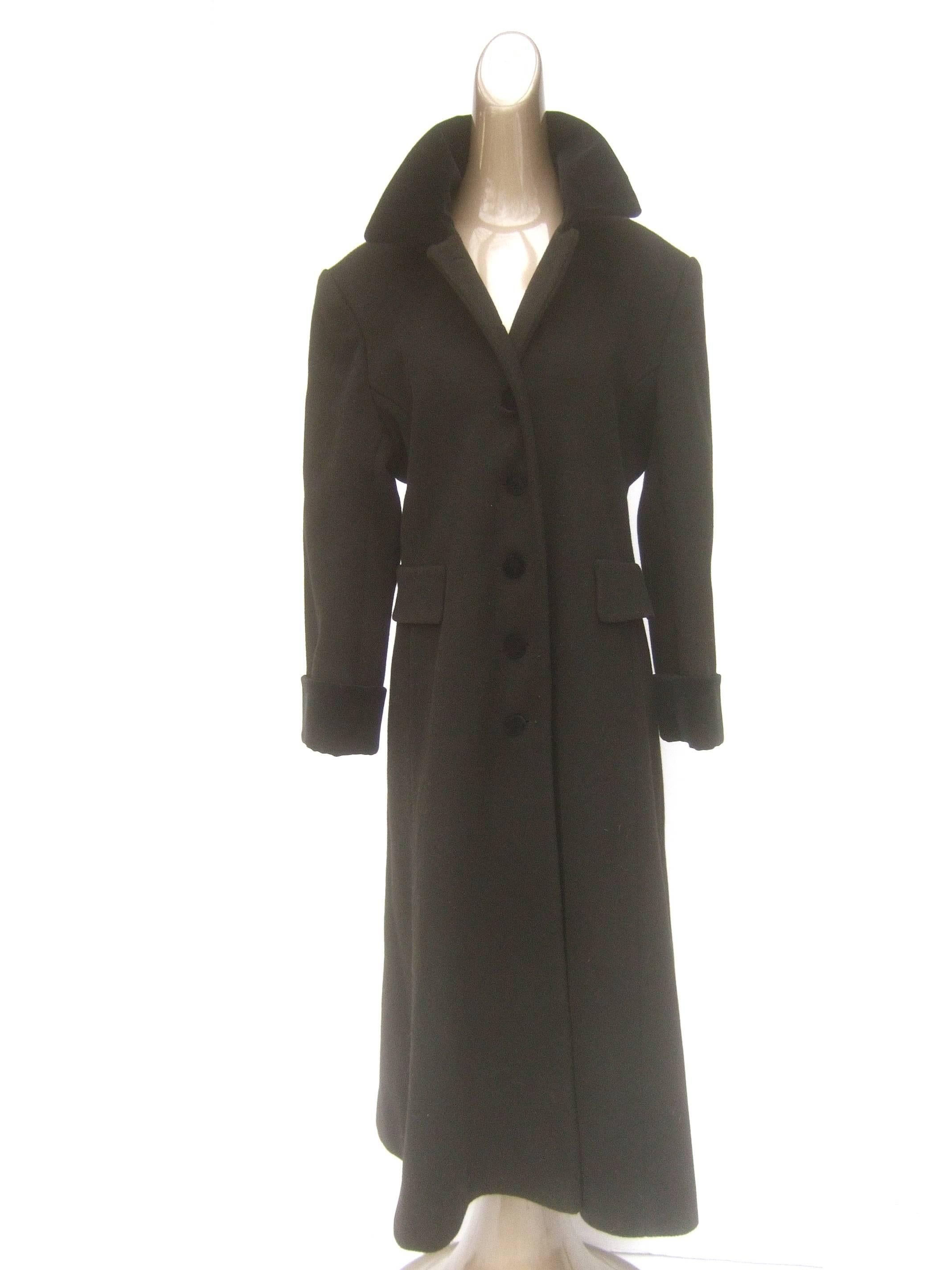 Halston H Black wool velvet trim coat c 1990s 
The classic black wool coat is accented with 
a black velvet collar, cuffs and velvet covered
buttons 

Designed with a pair of faux mock flap covered pockets 
Makes a stylish timeless garment
