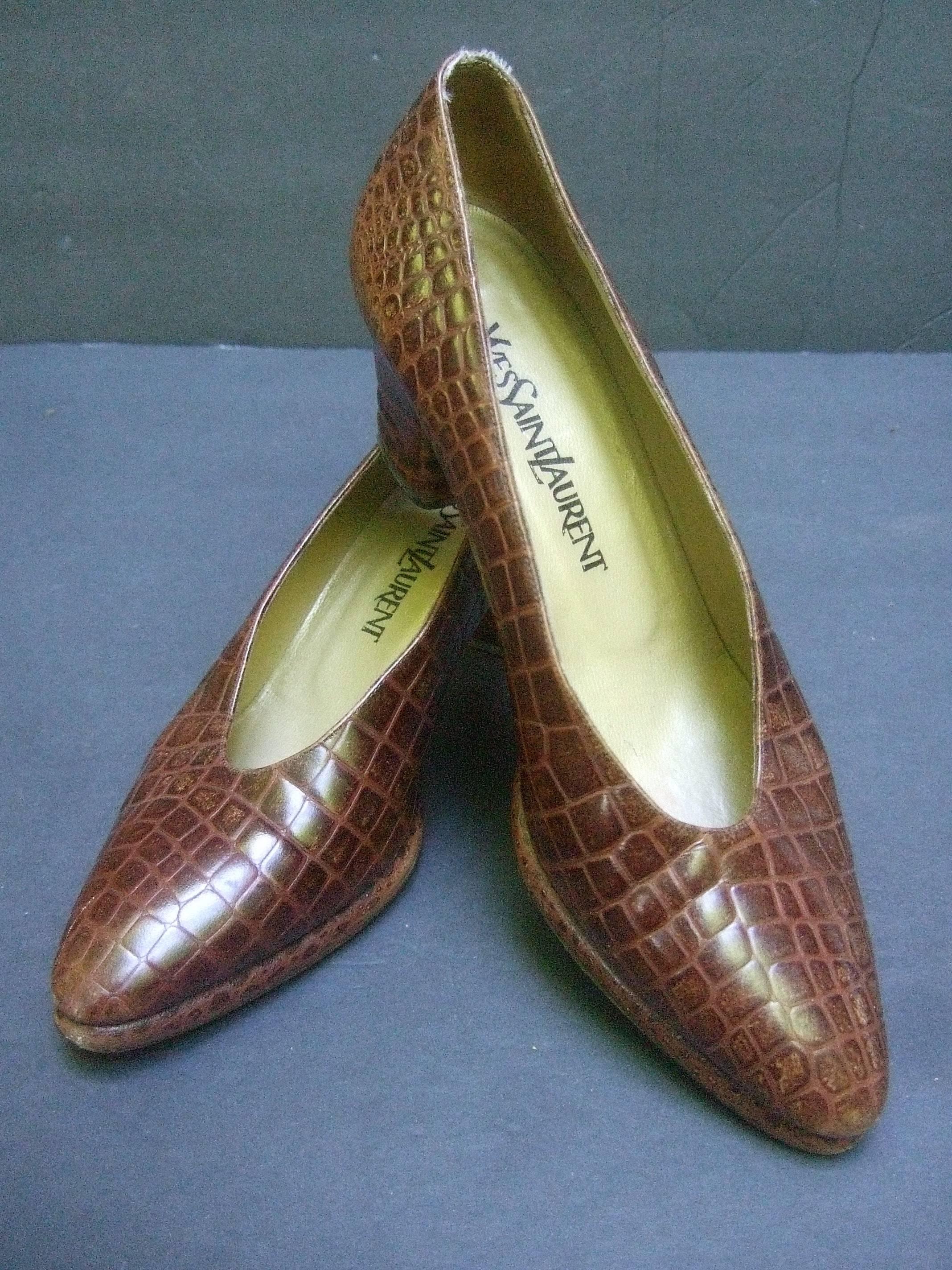 Yves Saint Laurent Italian embossed brown leather pumps US Size 7.5 M
The stylish Italian shoes have an embossed finish that emulates
reptile skin

The interior is lined in bronze color leather
The vintage 1990s era shoes make a classic