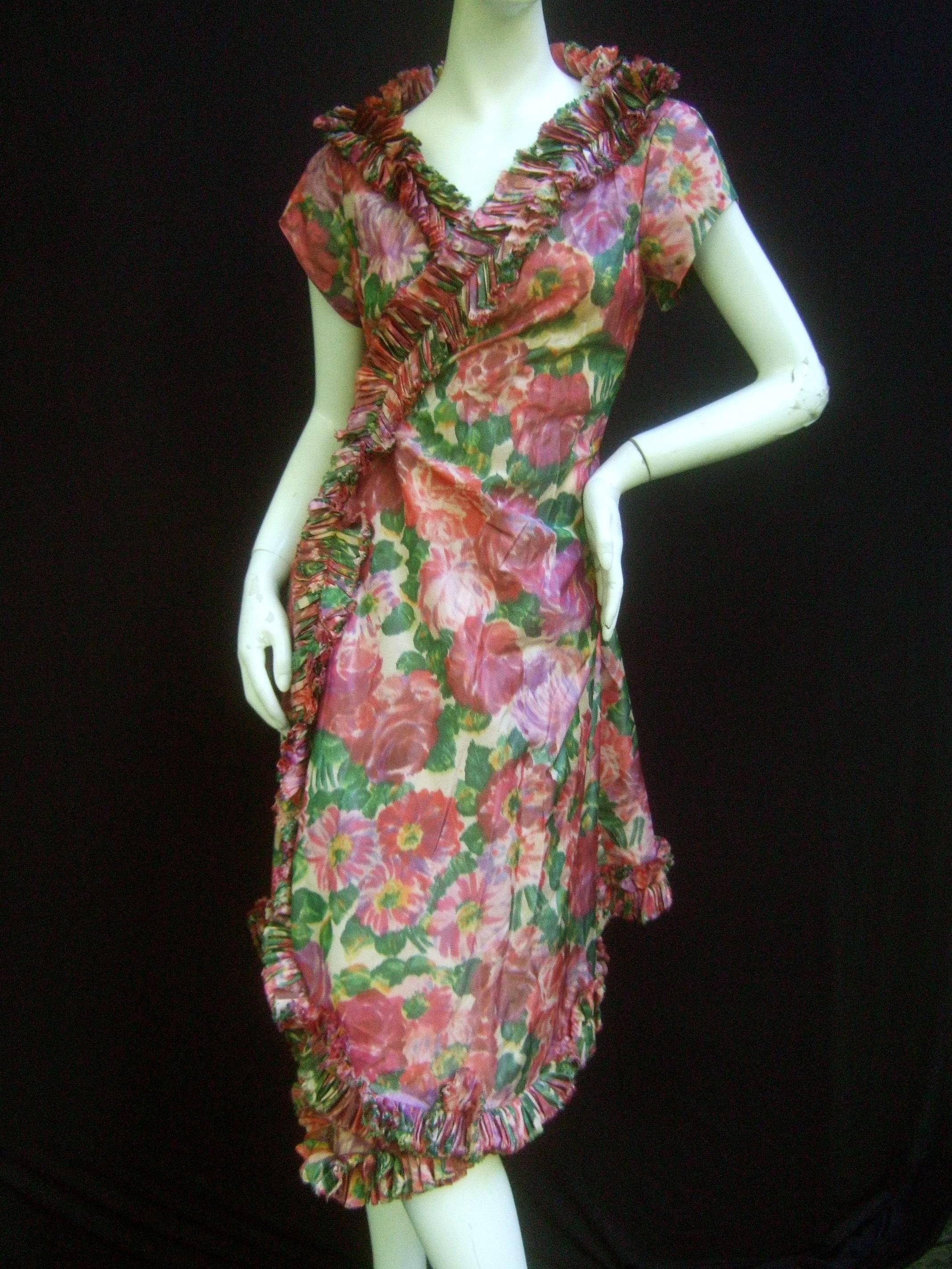 Lucie Ann Beverly Hills taffeta rose print wrap dress c 1960
The stylish romantic retro dress is infused with a lush garden 
of muted pastel rose blooms

The neckline, front opening and hemline are distinguished 
with a ruffled pleated border. The