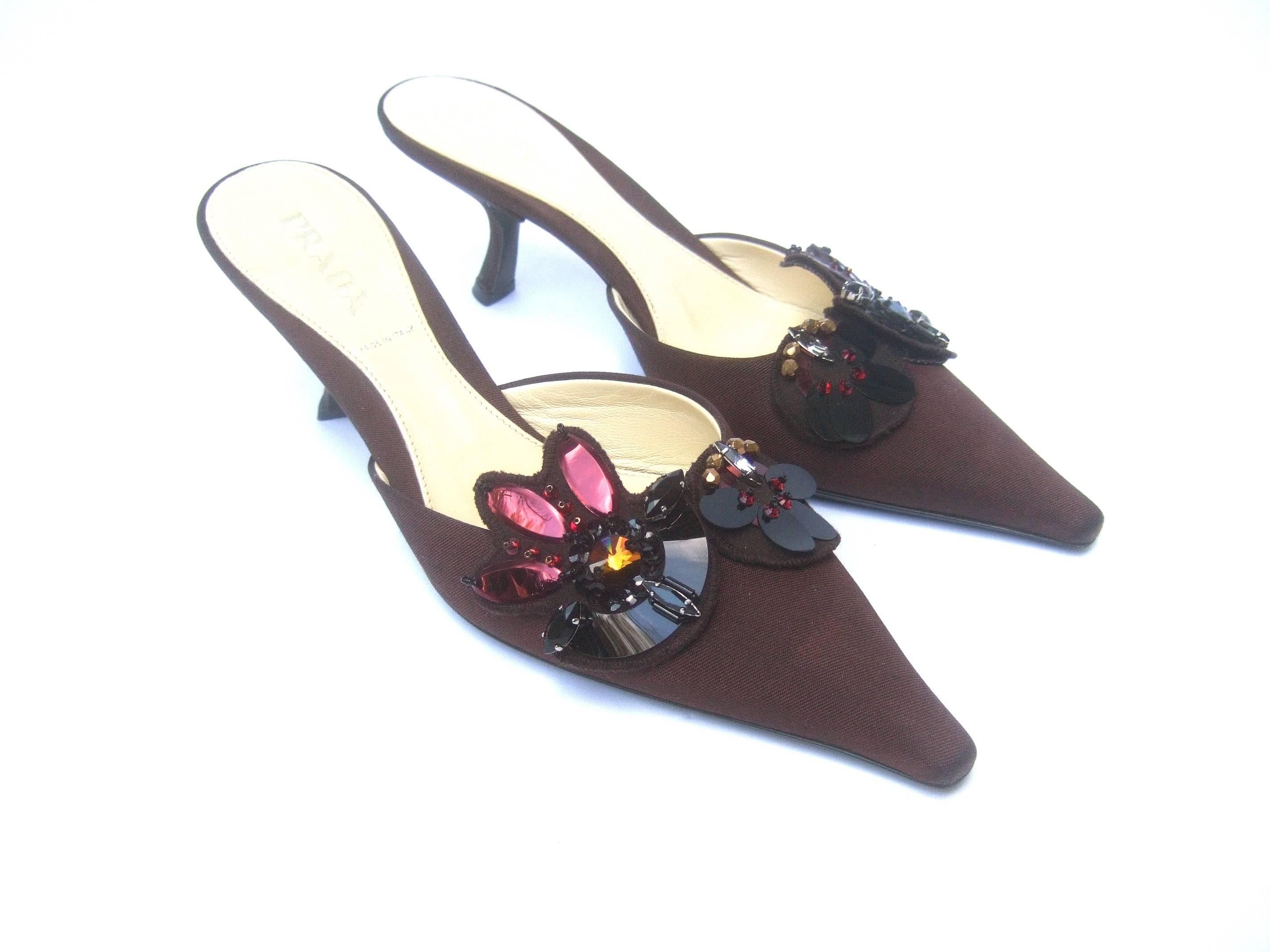 Prada Italy chocolate brown jeweled satin mules Size 37
The stylish Italian shoes are embellished glittering 
crystals and sequined palettes on the front

The pointed toe pumps are covered with dark brown 
satin fabric. Paired with the Prada shoe