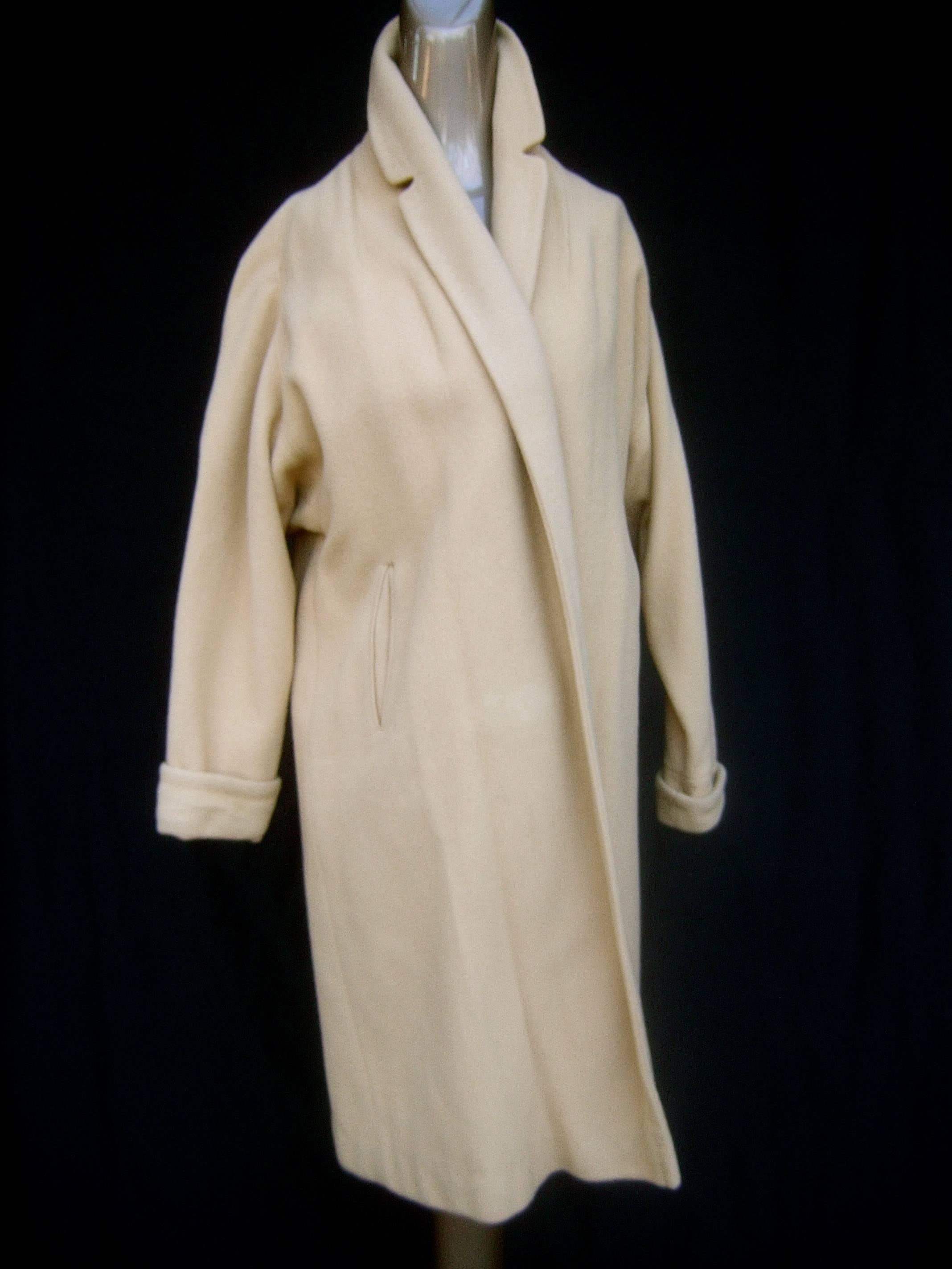 1960s Luxurious plush tan cashmere swing coat c 1960
The stylish mid-century coat is designed with soft
tan cashmere 

The retro coat is designed without buttons, closures
or a belt. Drapes over the body and partially reveals 
the garments worn