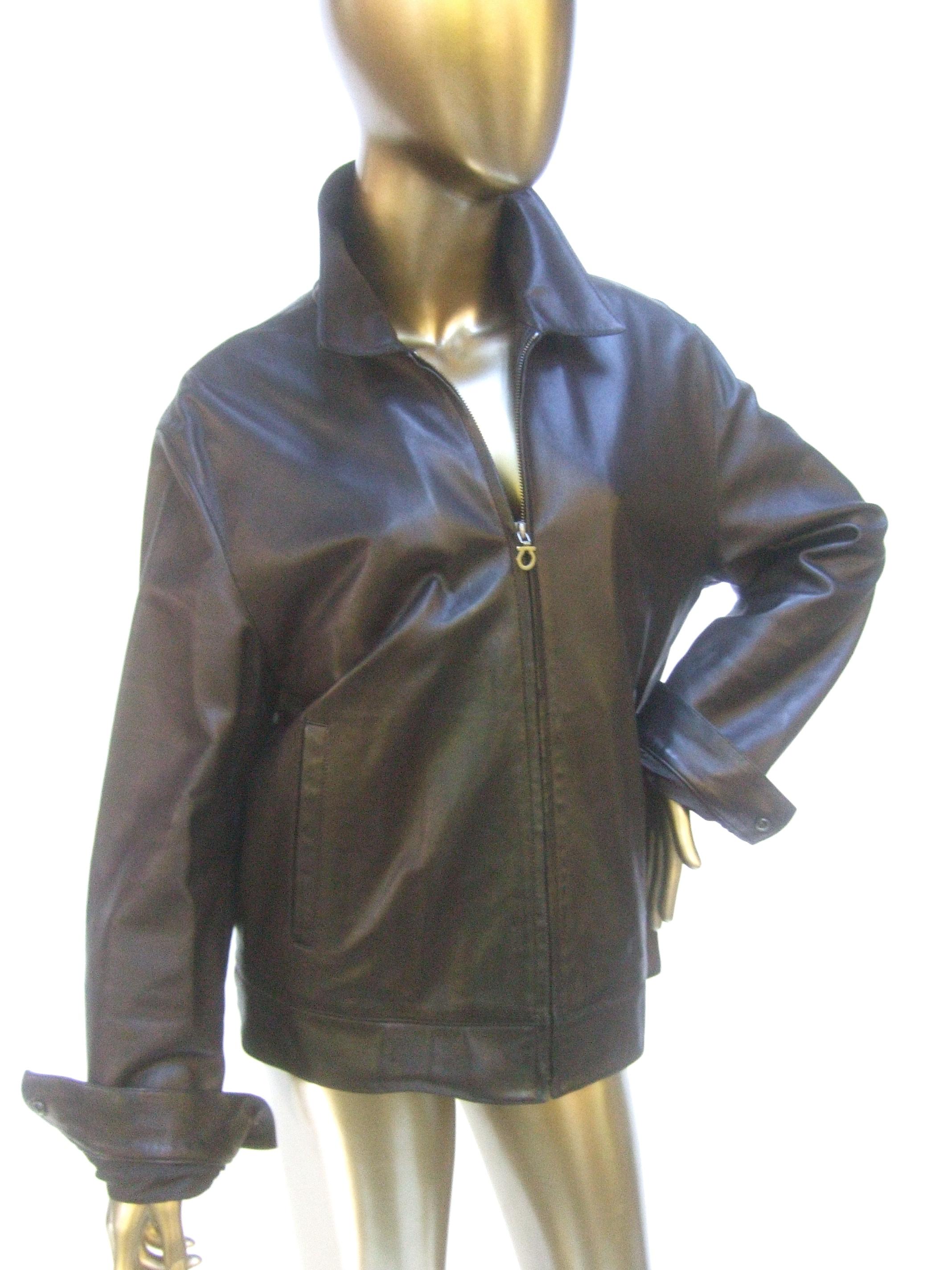 Salvatore Ferragamo Italian chocolate brown unisex leather zippered jacket 
The dark brown lightweight Italian leather jacket is buttery soft with a zipper
that runs down the center. Designed with a pair of slit pockets one on each
exterior