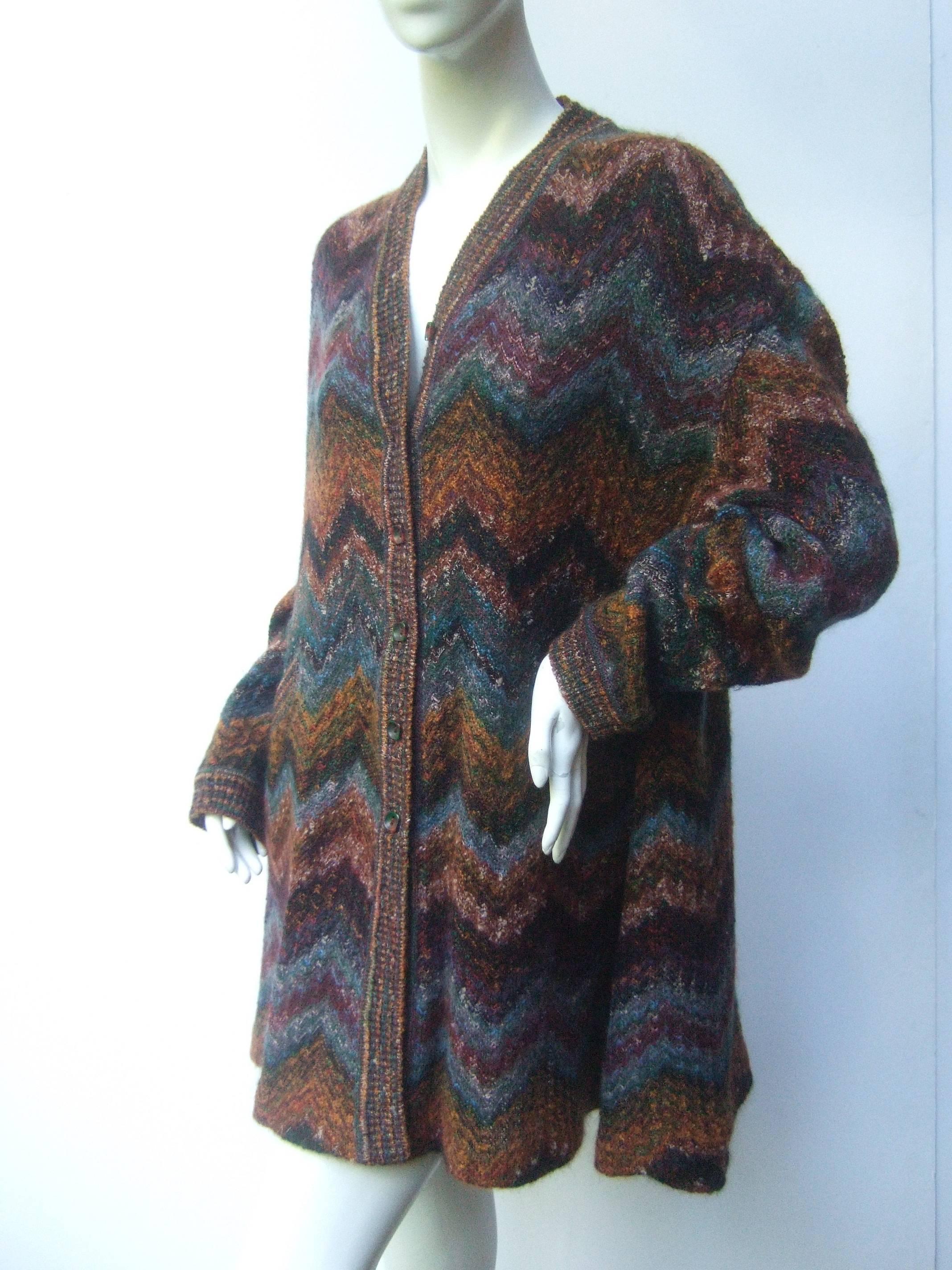 Missoni Italy Chevron wool knit long cardigan for Neiman Marcus c 1980s
The fuzzy wool knit cardigan is designed with Missoni's 
iconic zigzag chevron pattern

The autumn colors range from burnt orange, muted greens,
burgundy, eggplant with