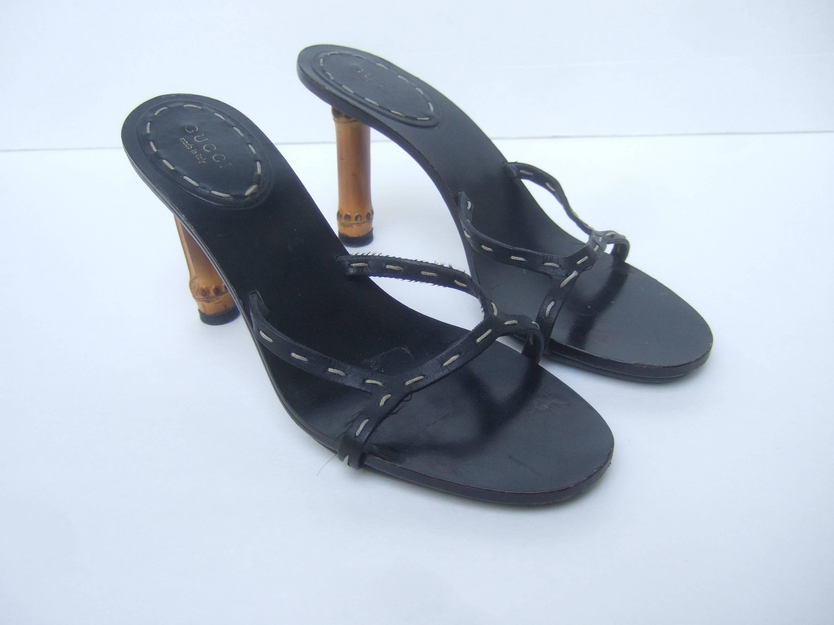 Gucci Italy leather bamboo heel sandals US Size 7B
The chic Italian black leather sandals are
designed with unique wood bamboo heels

The black leather straps are accented with 
wide white saddle stitch trim detail

Designed by Gucci Made in