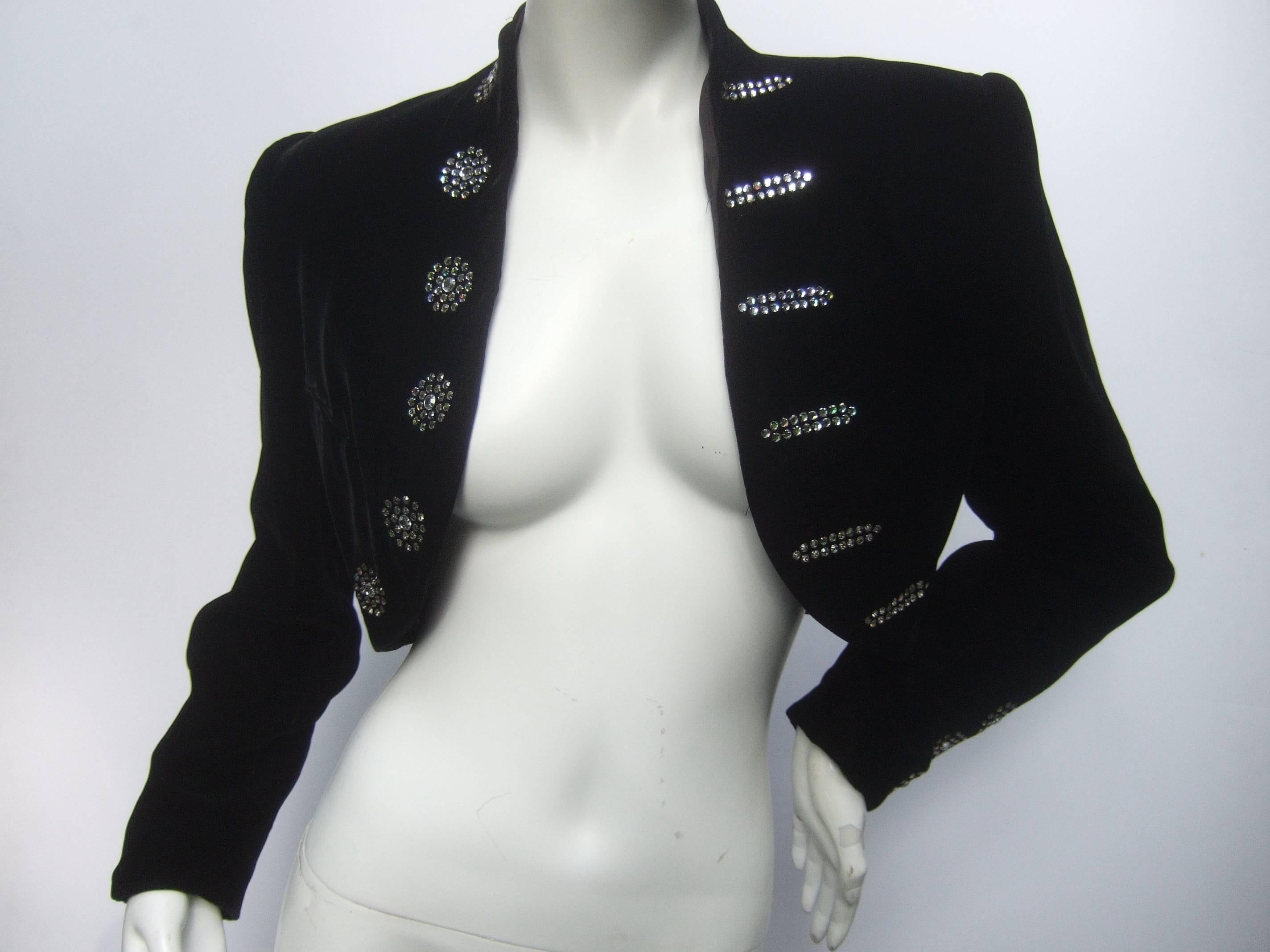 Black velvet crystal matador style bolero jacket 
The elegant cropped velvet jacket is embellished 
prong set diamante crystals that frame the opening

The plush black velvet sleeve cuffs are 
accented with matching diamante crystals
The