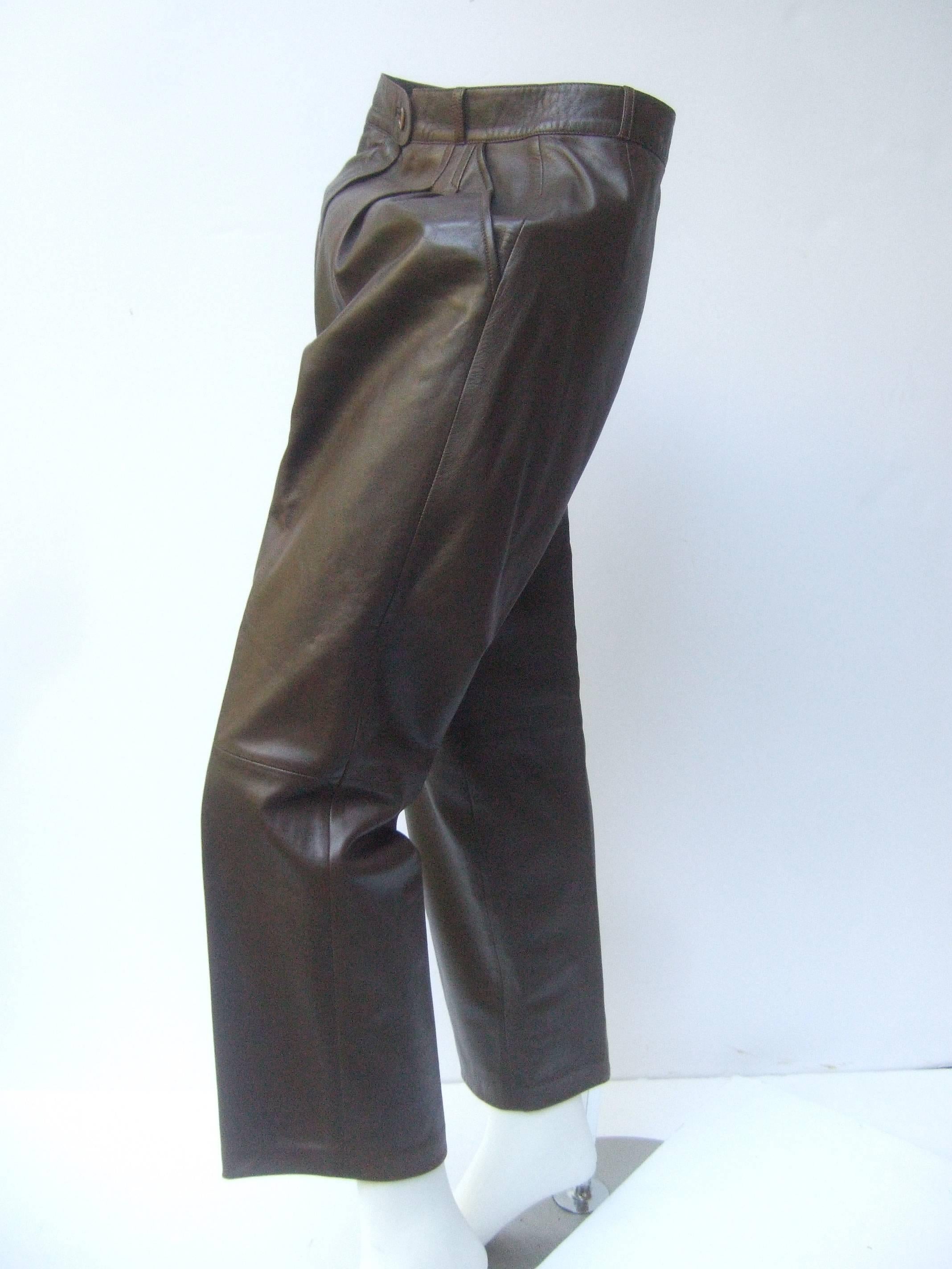 Gucci Italy Brown leather vintage slacks c 1970s
The tobacco brown leather slacks are 
buttery soft lined in brown satin acetate 
with Gucci's script signature repeated  
throughout

The high waisted supple leather slacks 
are designed with