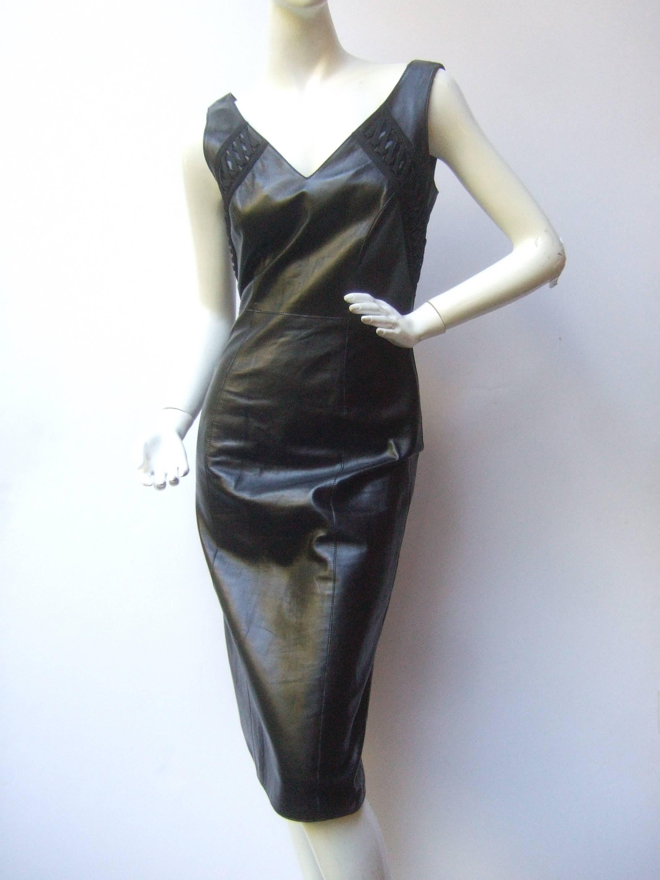 Christian Dior Paris Chic black leather bondage dress 
The stylish designer dress is constructed with supple
black leather with a slight sheen

The bodice and back side are accented with black
cloth crisscross lacing detail. The lacing detail