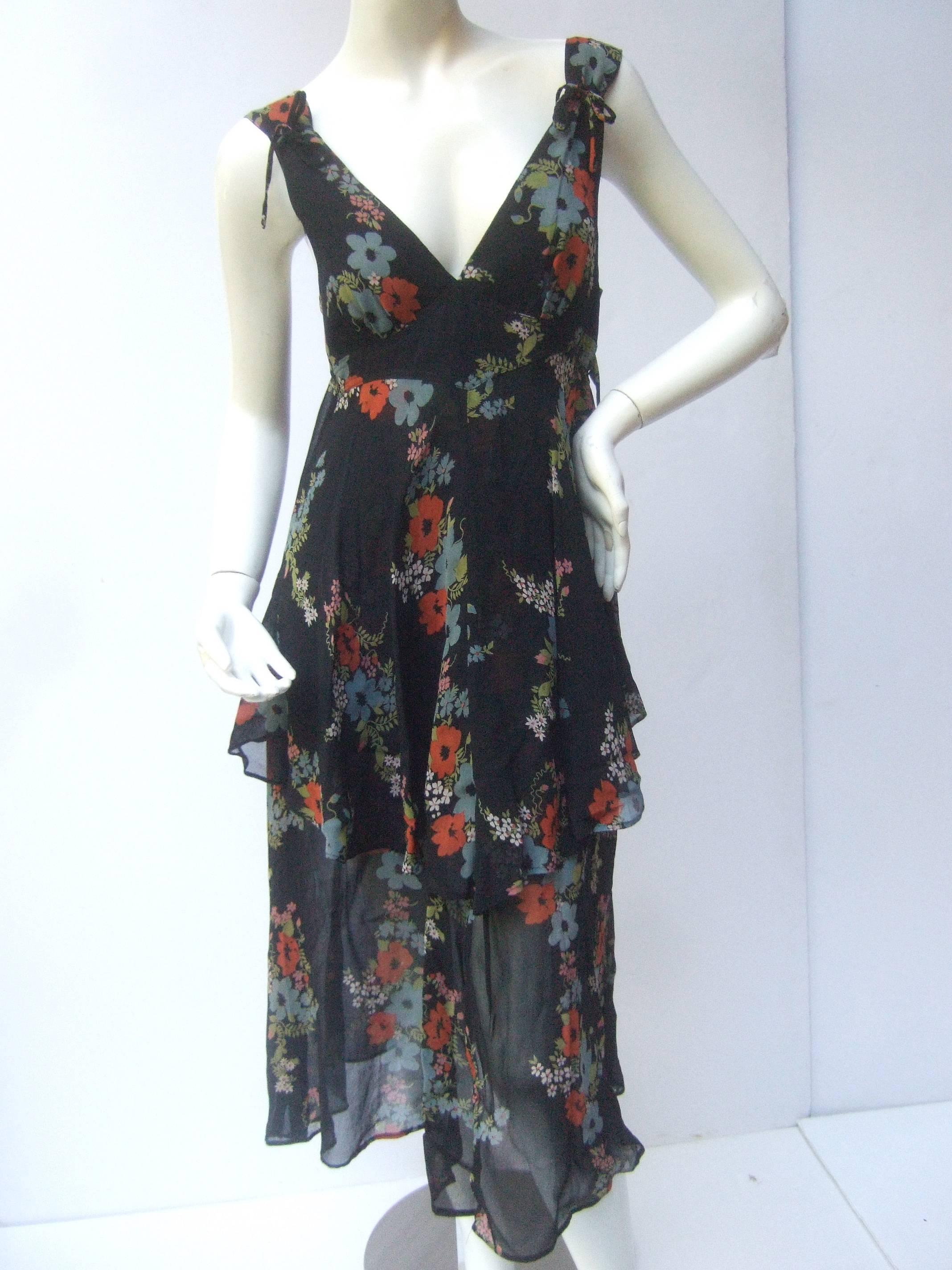 Ossie Clark Romantic floral print tiered crepe dress from the early 1970's.

The elegant tea style dress is designed with a Celia Birtwell
print.

The floaty crepe fabric is illuminated with a garden
of flower blooms that undulate with the