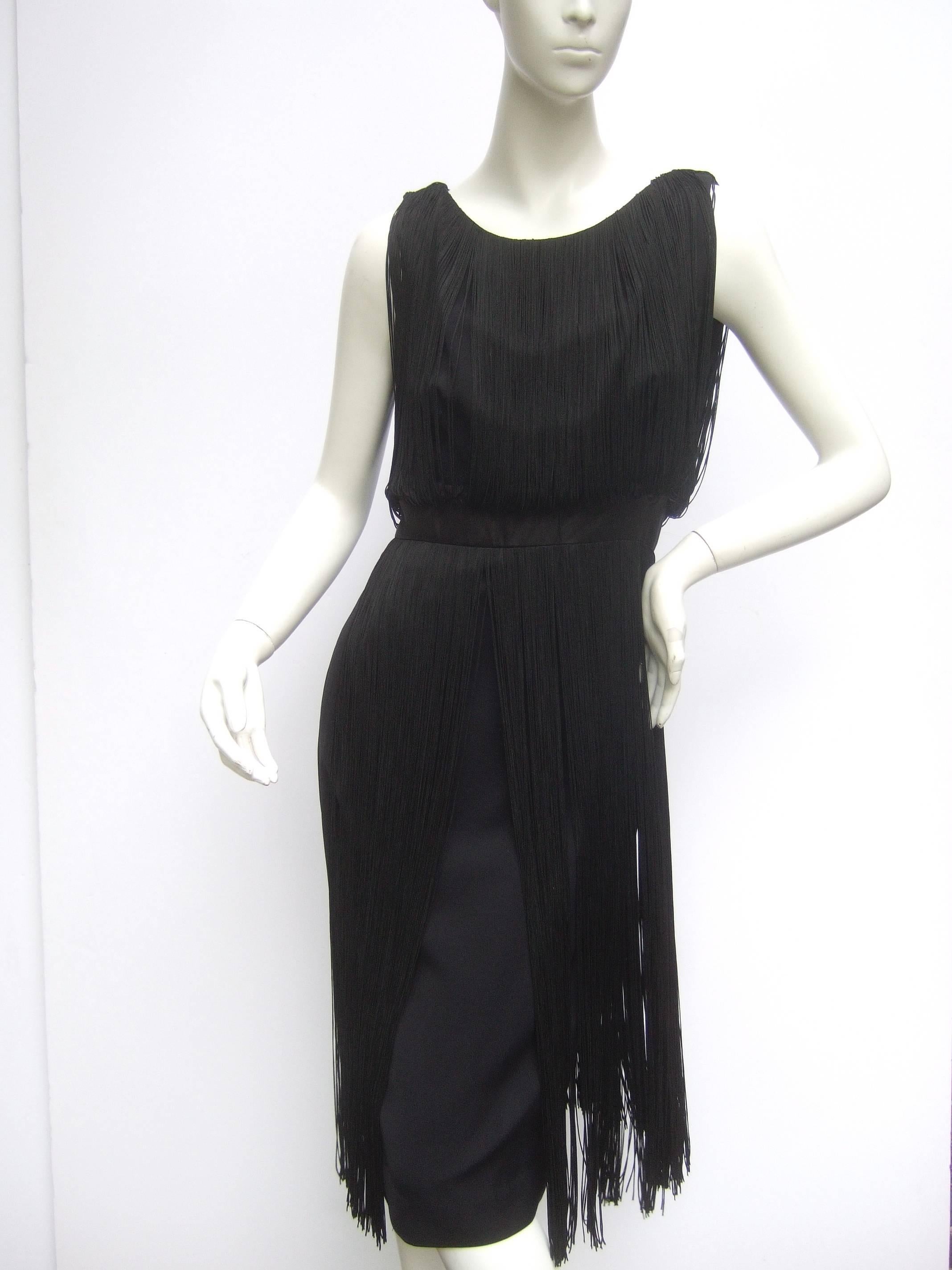 1960s Black fringe tassel cocktail dress
The chic retro cocktail dress is designed 
with contiguous stationary fringe that covers
the bodice and back side

The midsection is distinguished with
a black satin band the circles