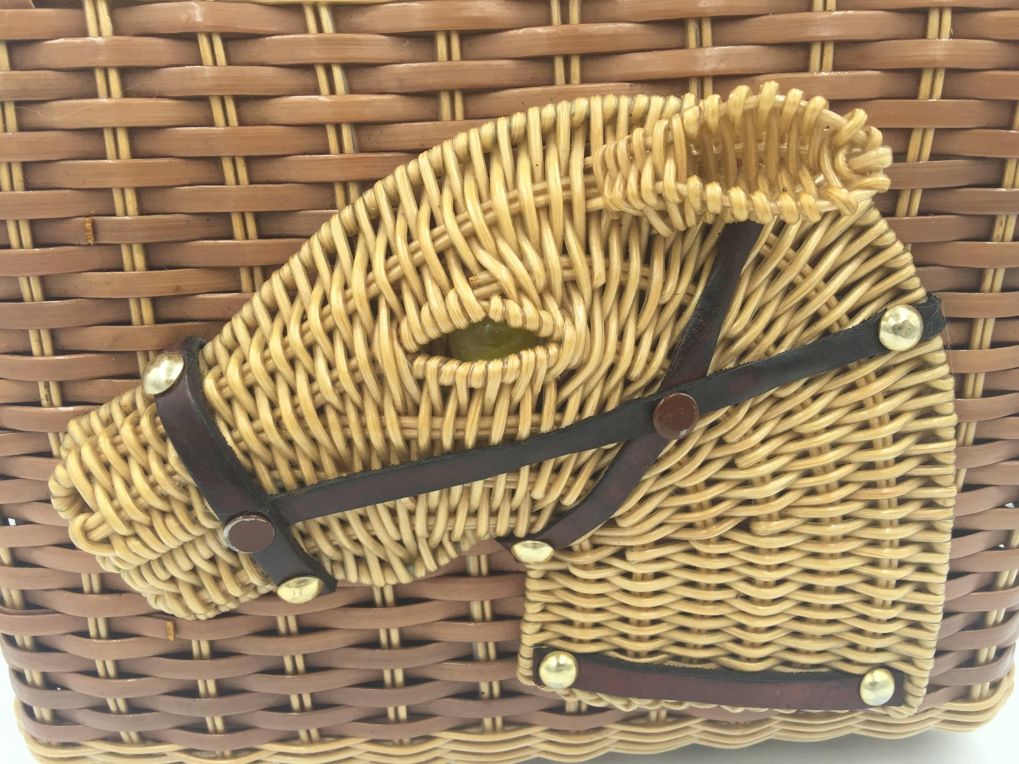 Rare and wonderful vintage wicker bag by Stylecraft of Miami. 

The wicker is coated for a smooth finish.

Here, a 3-dimensional portrait of a regal looking horse is rendered in wicker, leather, and brass tacks.  The inset eye is made of clear