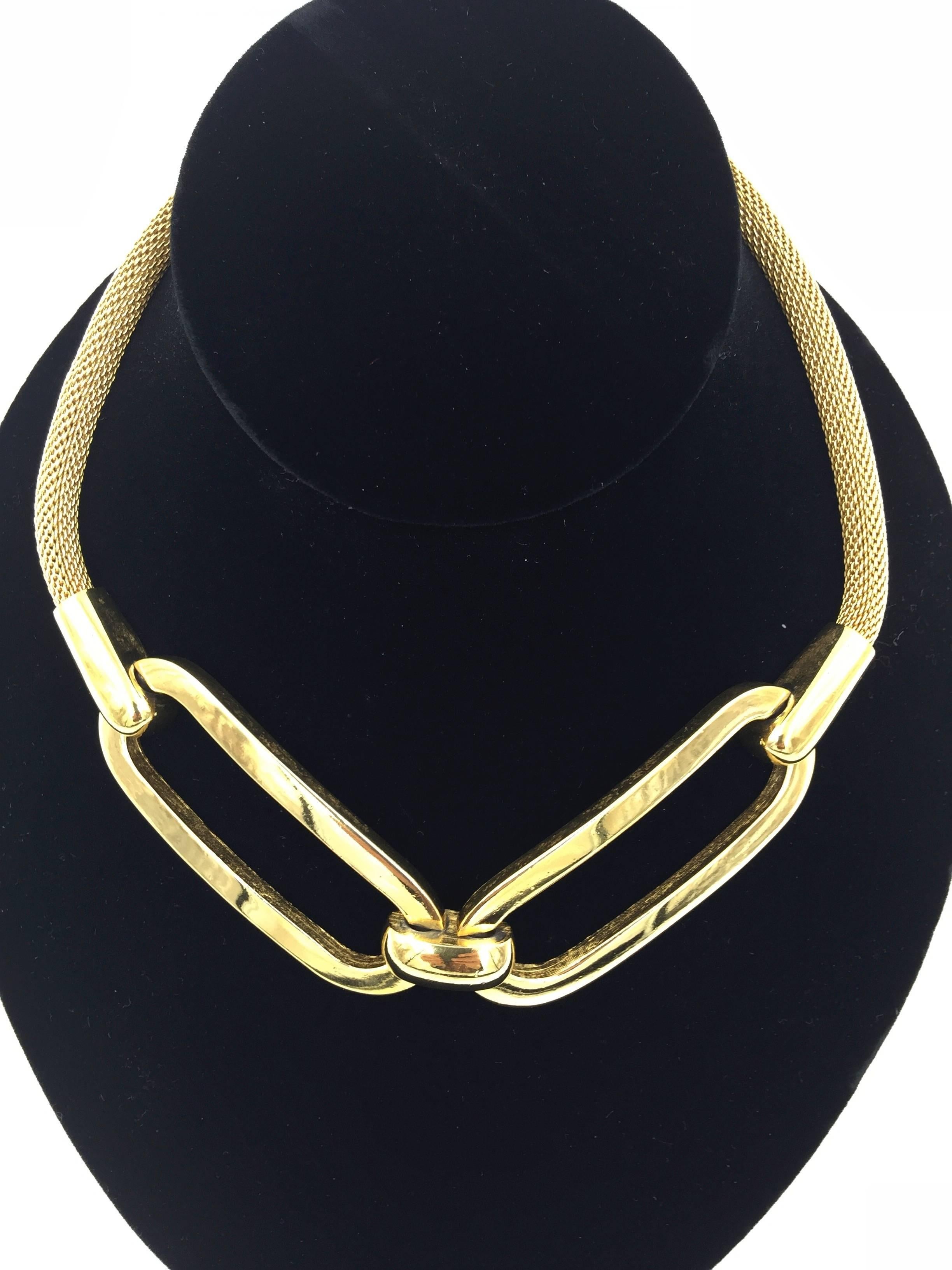 
This piece is wonderfully bold and graphic.

Givenchy gold toned necklace comprised of two joined
ovals suspended from a snake chain.

Epitomizes that sleek 1970's New York style,
think Halston and Studio 54!

Fabulous quality. Really