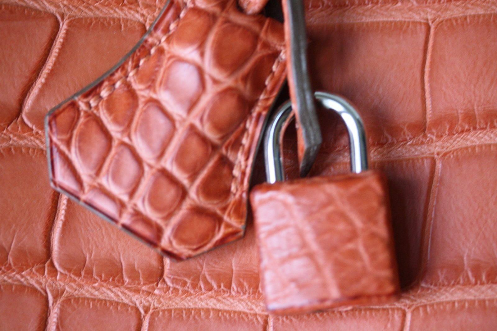 Hermès 40cm Birkin in beautiful Matte Alligator with palladium hardware. Luxuriously rich Hermès orange colour with tonal top stitching.

Year: Date stamp is a O in a square - 2011 production.

Condition: This bag has only been used lightly, there