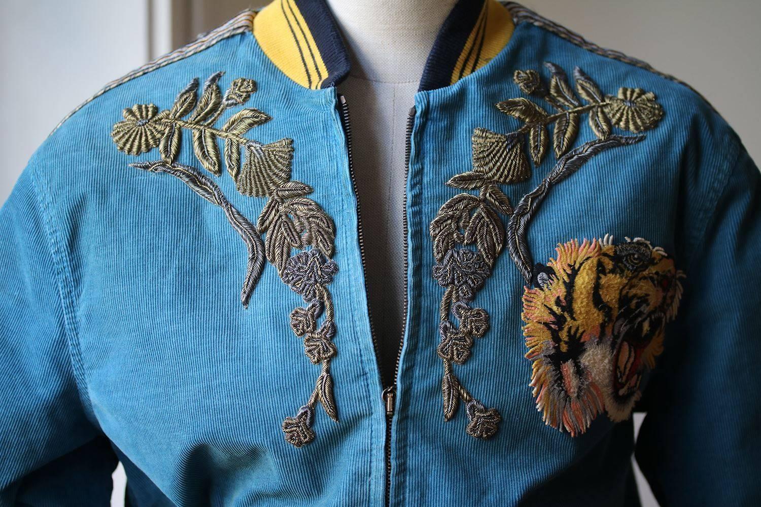 Gucci's teal-blue corduroy bomber jacket comes decorated with an eclectic combination of motifs – a roaring tiger's head sits on the chest, and a vivid dragon is framed by a white ‘Loved’ slogan and flower appliques on the back. It's crafted in