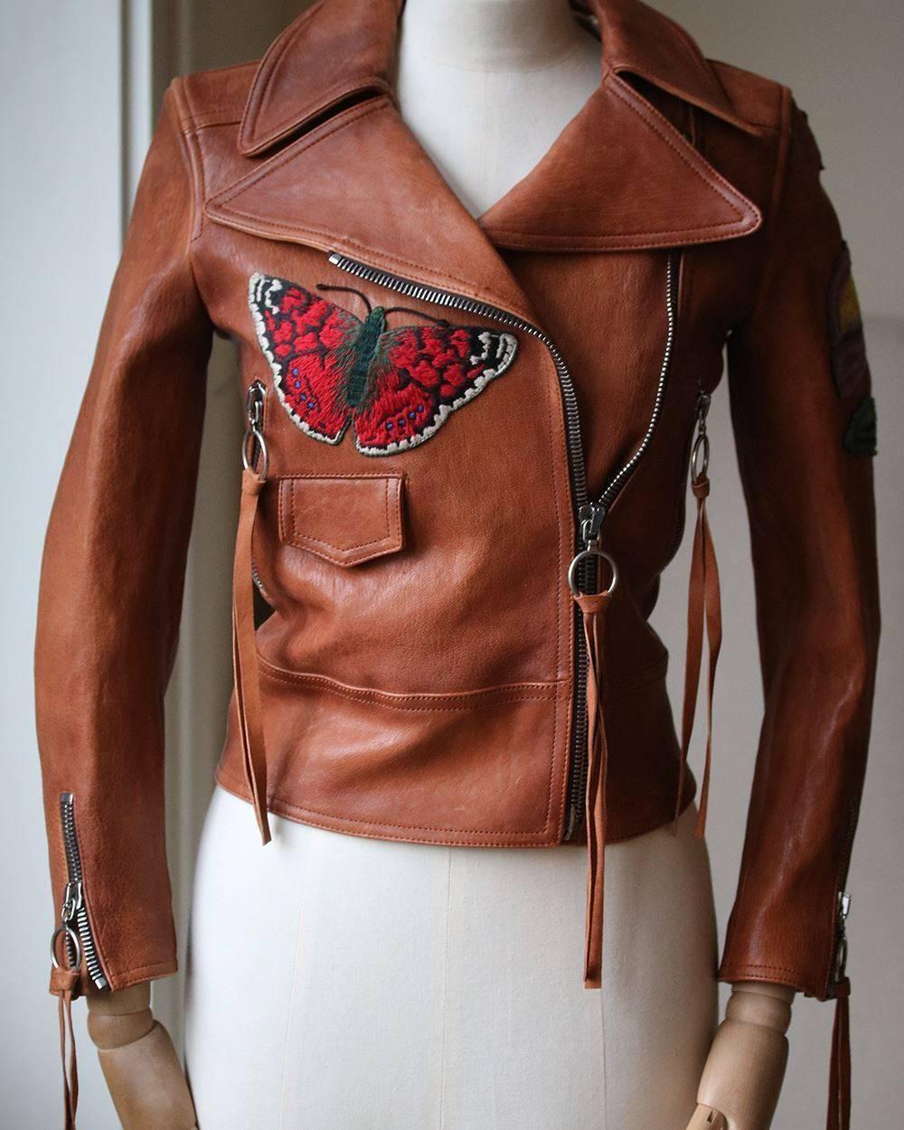 Alessandro Michele brings his eclectic touch to this Gucci leather jacket. It's crafted in Italy from lightly-grained lamb leather and features lapels and expandable zip cuffs. Intricate embroidery is appliquéd across the back and front which