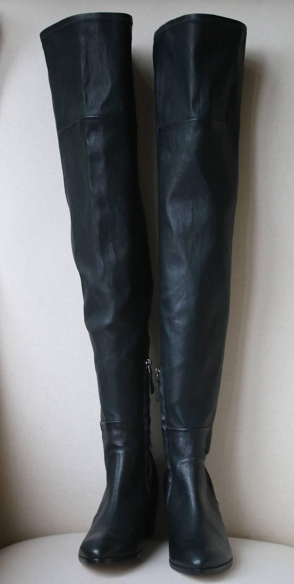 Chanel dark green stretch-leather over-the-knee heeled boots featuring a metal 'CC' logo on the heel. Pulls on.

Size: EU 38 (UK 5, US 8)

Condition: New without box. 

Please note: These boots do not come with their dustbag or box. 