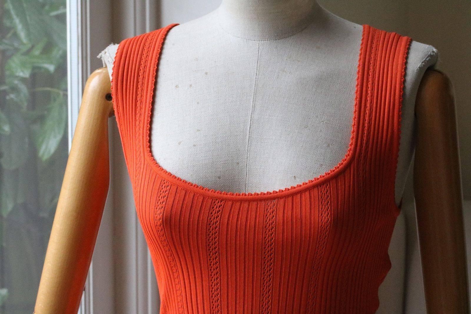 An incredibly elegant vintage orange dress by Azzedine Alaia. From the 1990's, this dress is seamless with a scoop neckline. The neckline flatters the bust and the cinched in waist hugs the hips to drape off into a long skirt. In rayon jersey