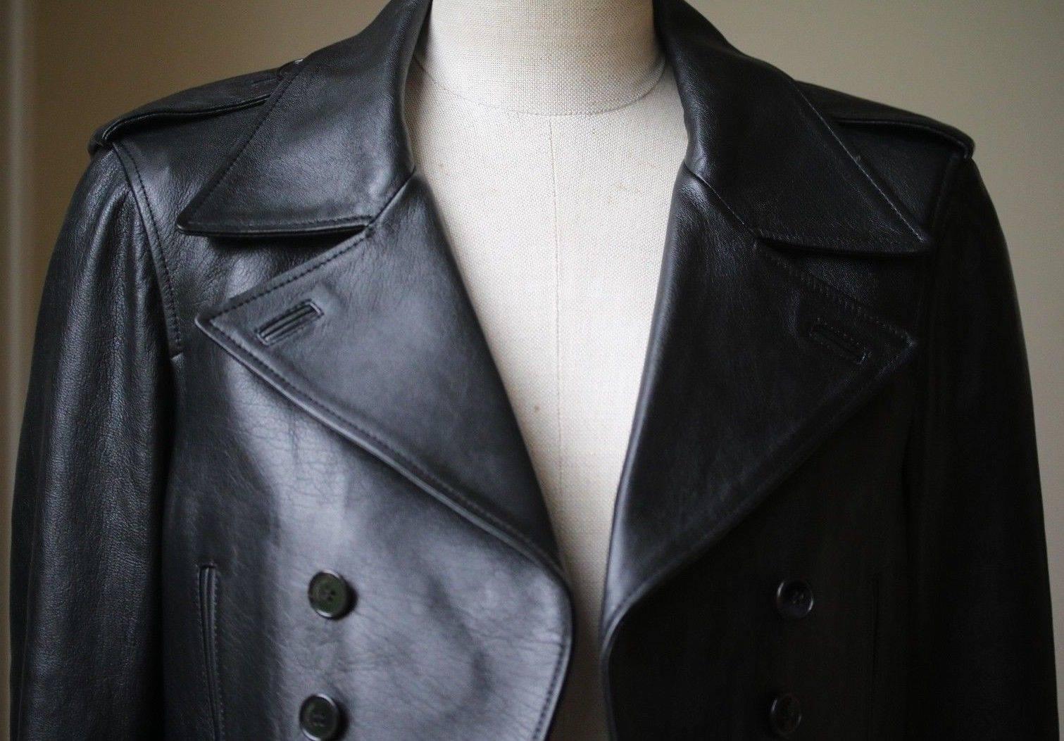 Black cotton and lamb skin cropped leather jacket from Saint Laurent featuring notched lapels, buttoned shoulder tabs, long sleeves, button cuffs, side slit pockets and a double breasted front fastening. Color: black. 100% Leather. Comes up