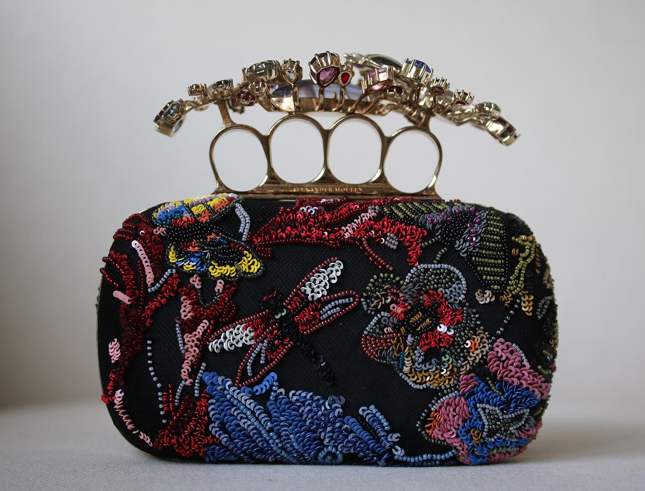 Multicolour beaded wonderland embroidery Short Knuckle Clutch; features Swarovski crystal floral knuckle holder, suede body of the clutch and a chain strap. Brass hardware with a gold finish. 80% Brass, 20% satin.

Dimensions: W 16 x H 12 x D 5