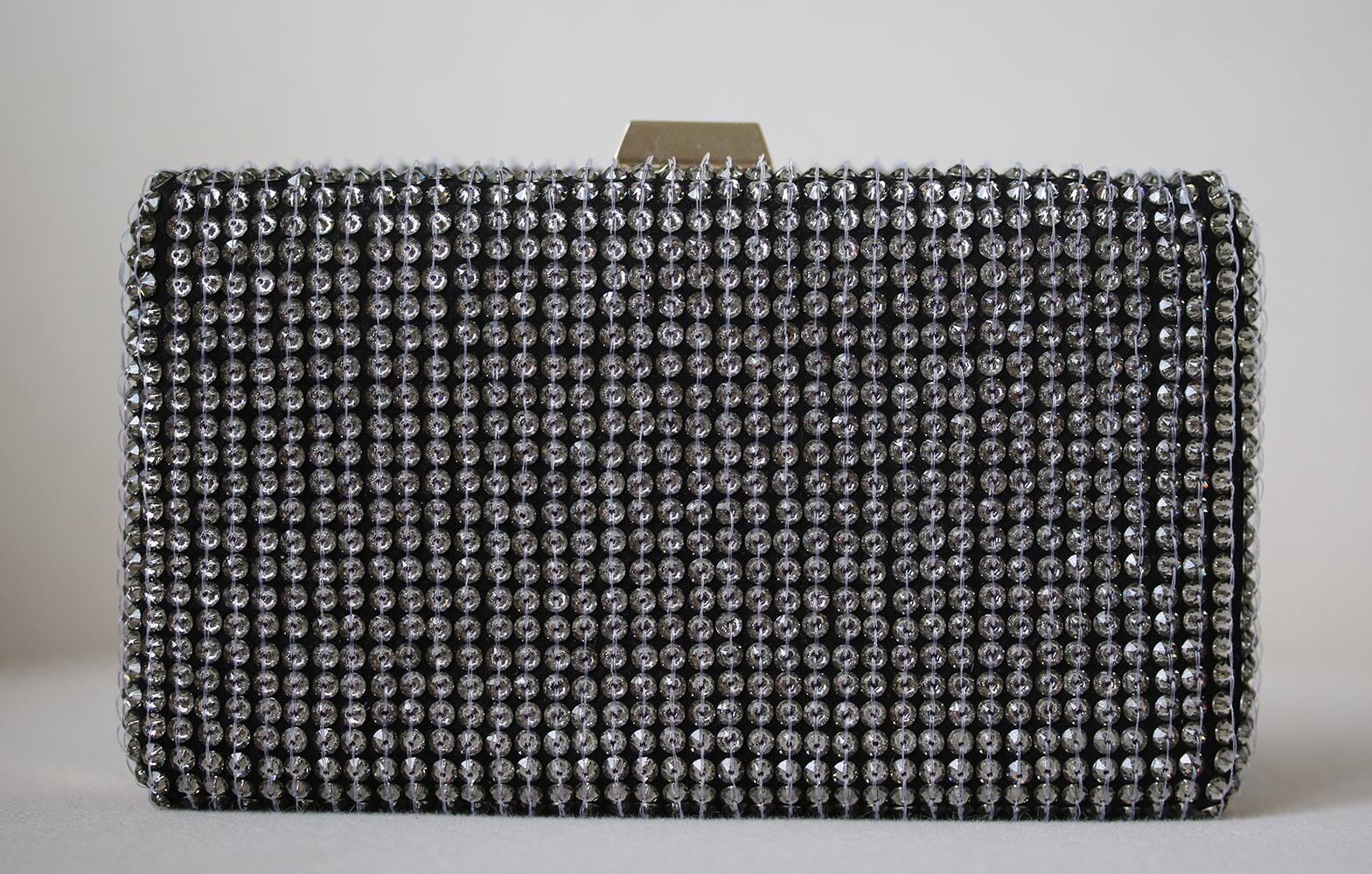 This beautiful Valentino Garavani Leather Crystal Clutch Bag features a sleek and sophisticated shape with black sparkling crystals throughout. This clutch as it comes with detachable strap. You will love that his bag is edgy yet still undeniable