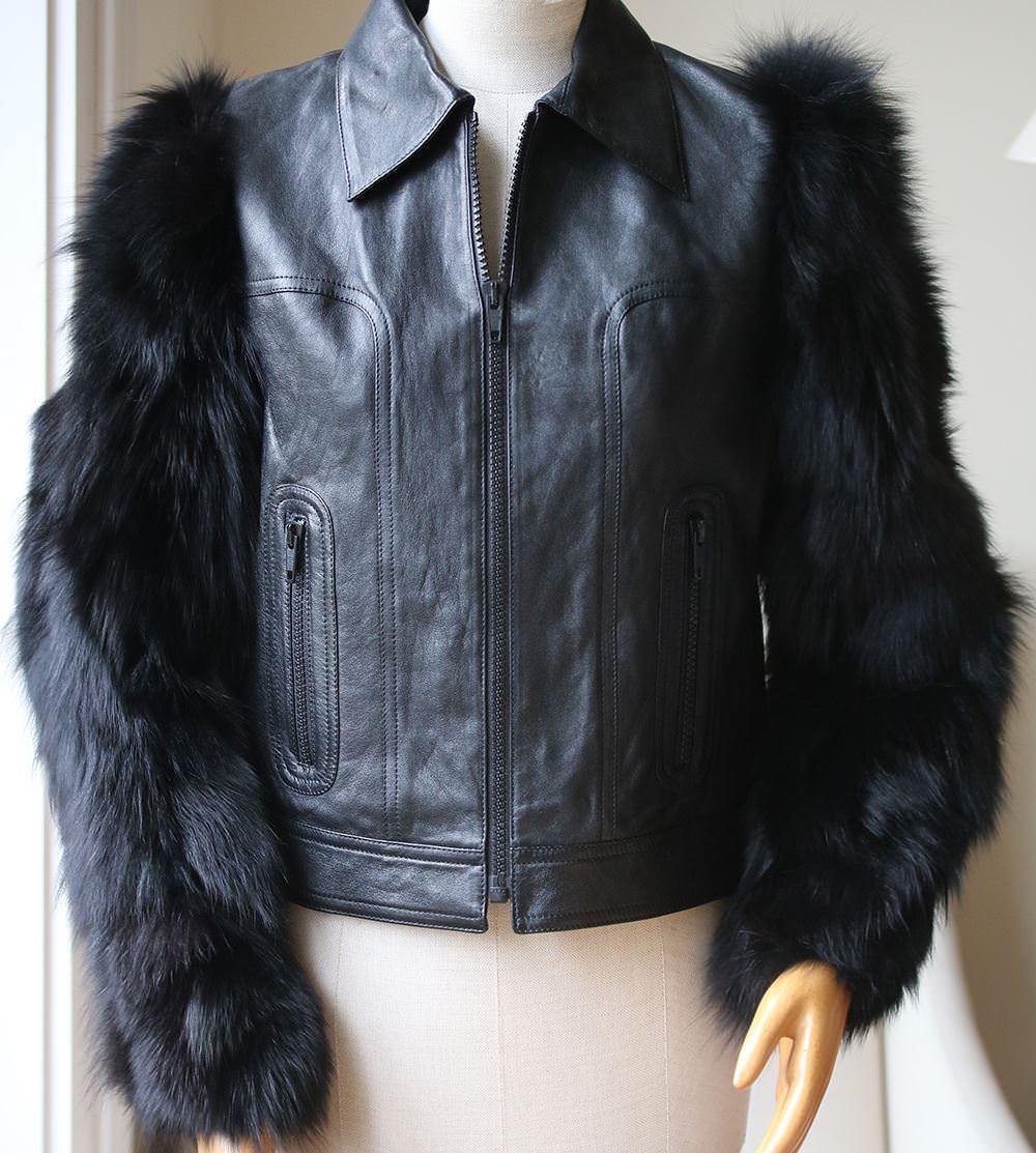 A classic black leather biker jacket is a wardrobe essential and timeless styling option. This Saint Laurent version has been revamped with luscious fox fur sleeves for a daring take on a classic silhouette. An example of Saint Laurent's made in
