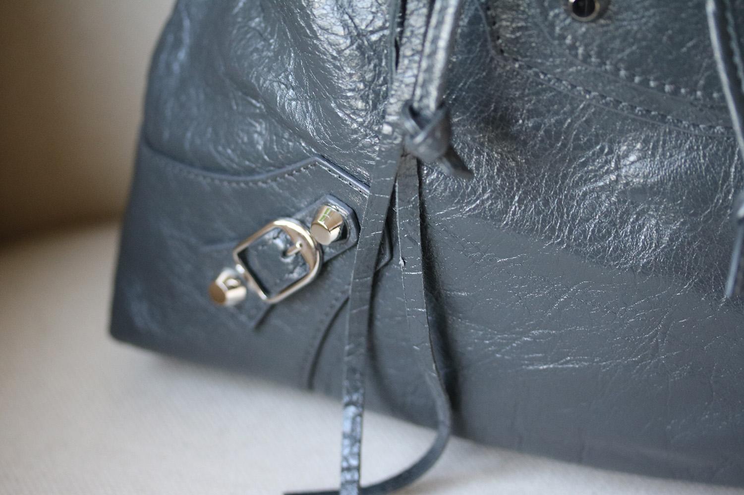 Balenciaga's 'Classic Traveller' backpack is punctuated with the house's signature polished studs and a whipstitched top handle. This piece is crafted from glossy grey textured-leather and has a hard-wearing canvas lining. Grey textured-leather