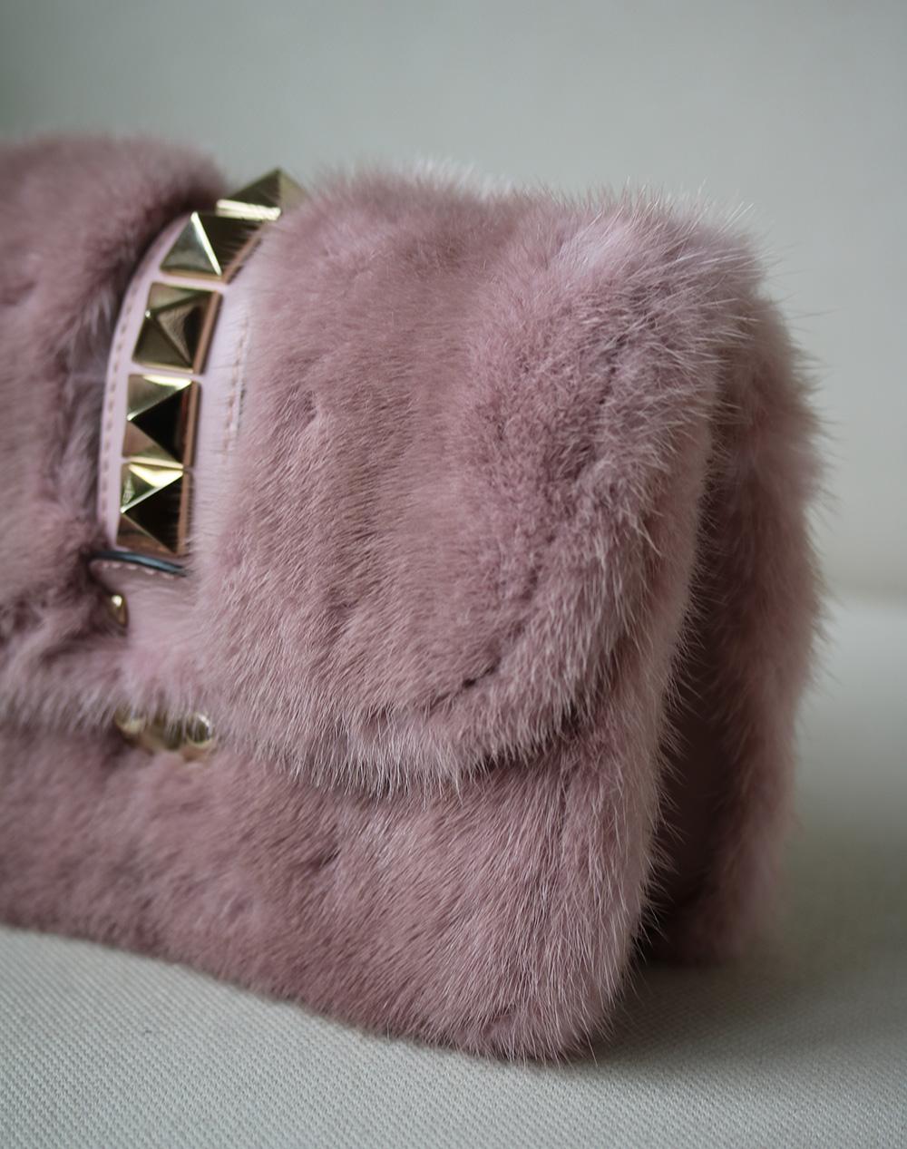 Valentino Garavani's Lock Small shoulder bag, a fan favourite, is back in a lush and dense mink fur design. The chartreuse hue is complemented by dusty pink leather trims and the iconic golden Rockstuds. Material: mink fur. Trim: leather,