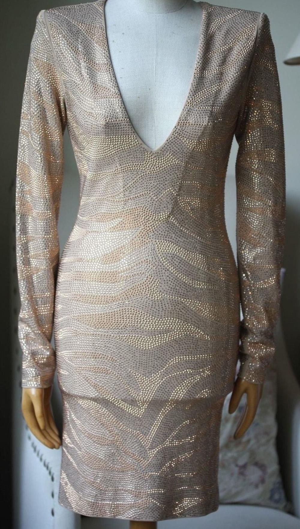 Balmain's long-sleeved beige mini dress is a major party piece. Covered in shimmering sequins to resemble a tiger motif, this silk-lined crepe piece has a close fit, a flattering V-neck and padded shoulders - a brand signature. 

Size: FR 36 (UK 8,
