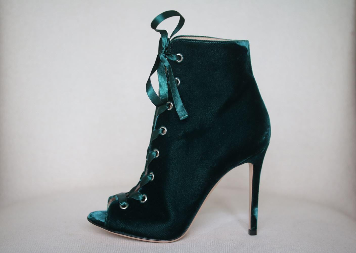 Gianvito Rossi's lace-up boots are made from petrol velvet and detailed with glossy satin ties - perfect for showcasing a pair of glittered or fishnet socks. This peep-toe style rests on a slim 100mm heel. Heel measures approximately 100mm/ 4