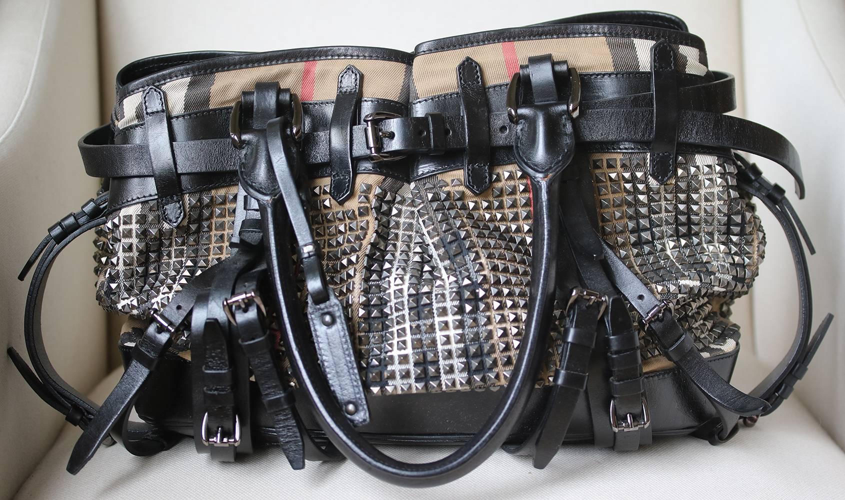 Rather Large Sized Bag Crafted In Canvas With The Welknown Burberry Check In Beige, Black, White And Red, Covered With Hundreds Of Silver-Tone Studs. Combined With Black Leather, Numerous Decorative Leather Straps At The Front Plus A Burberry Logo