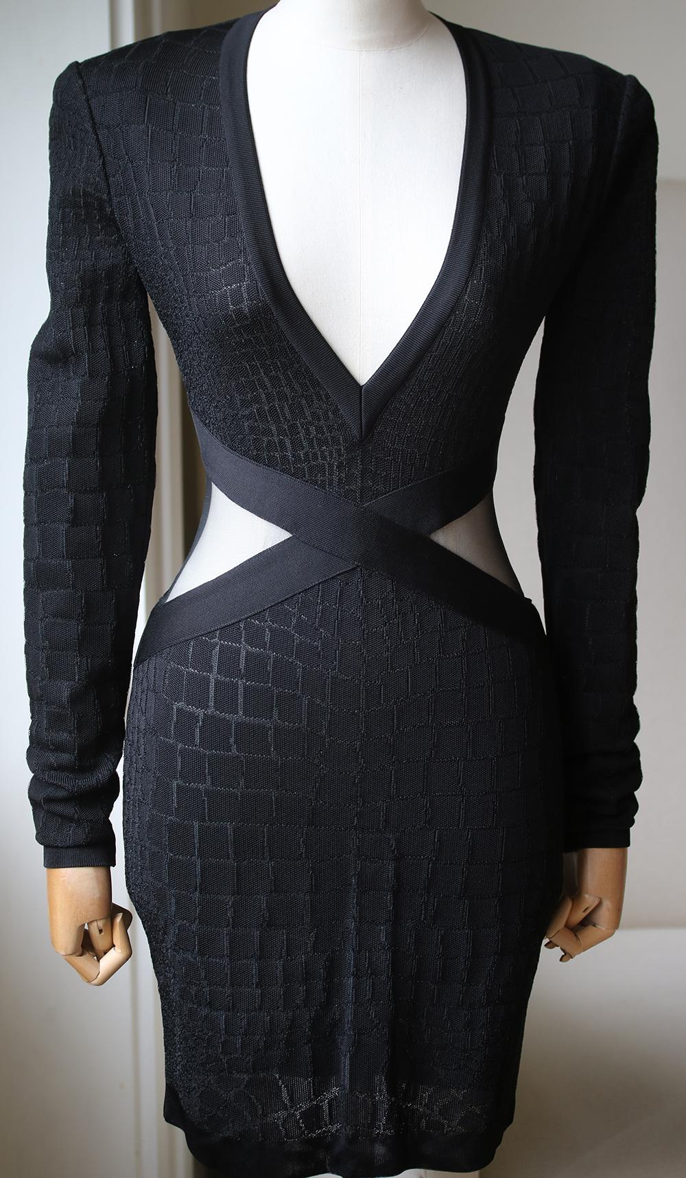 Balmain's dress is made from stretch-knit that's woven with a tactile croc-effect finish. Designed to create an hourglass shape, this sculpting piece has structured, padded shoulders and mesh panels that wrap around the narrowest part of your waist.