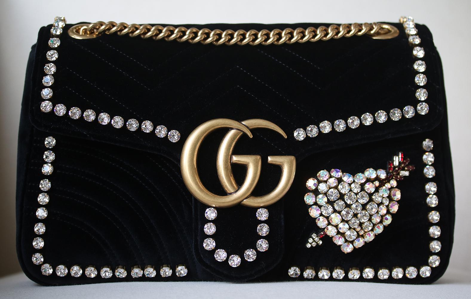 The GG Marmont Chain Shoulder Bag Exclusive to Saks Fifth Avenue Has A Softly Structured Shape And An Oversized Flap Closure With Double G Hardware. The Crystal heart adorns the bag. Crystal edging. The Sliding Chain Strap Can Be Worn Multiple Ways,