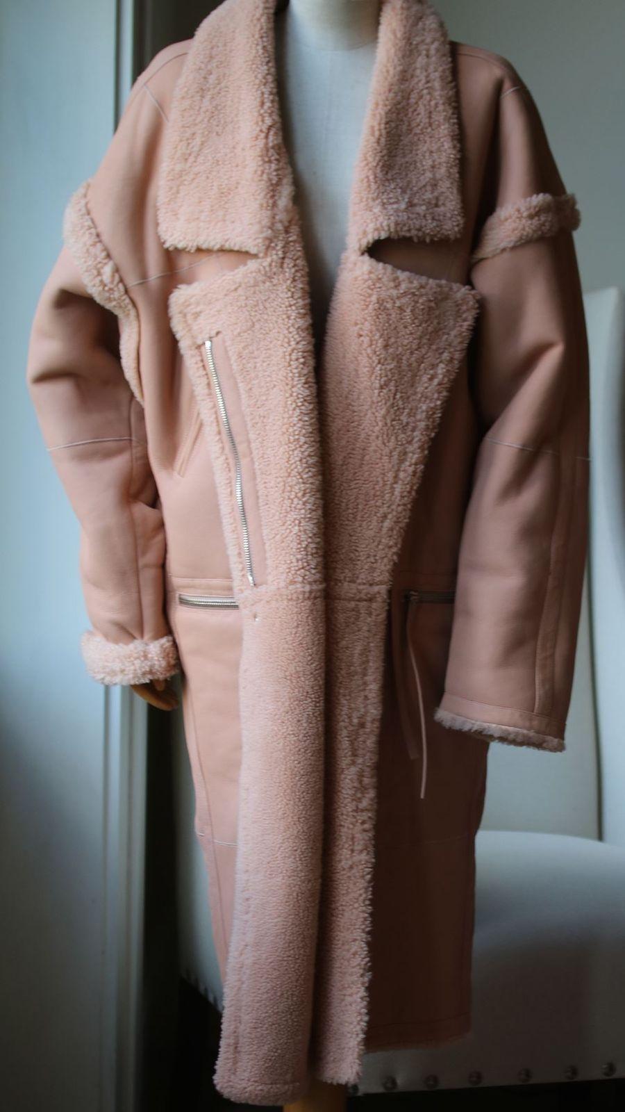 In an oversized fit, the Maples Riot coat by Zimmermann is crafted from plush panels of shearling. In a feminine blush pink, the coat offers an exaggerated winter profile with it's long length and dropped shoulders, featuring peak lapels and zipped