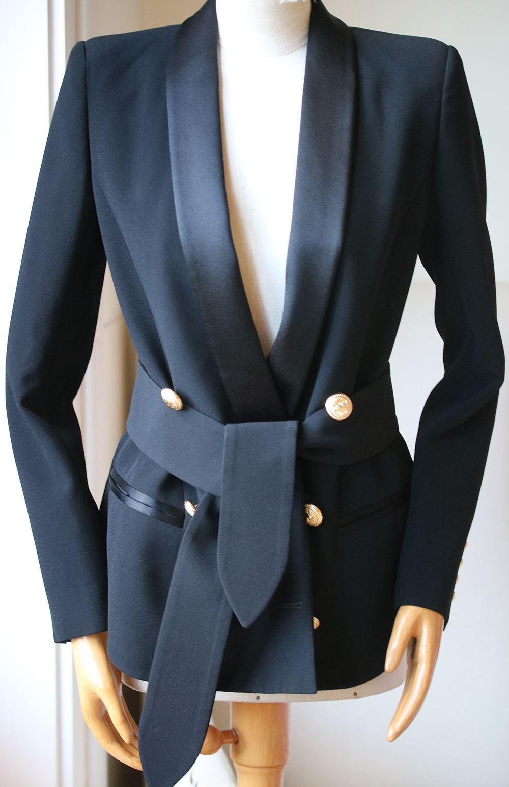 Balmain's tuxedo-style blazer is a prime example of Creative Director Olivier Rousteing's expert tailoring skills. Crafted in Italy from structured crepe in a deep black shade, this double-breasted style is decorated with the brand's iconic