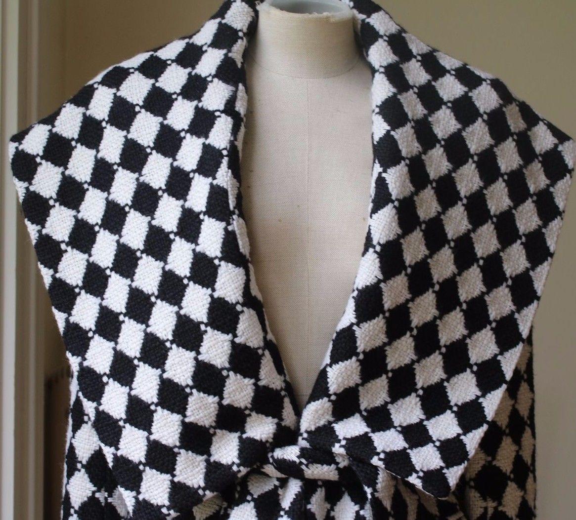 Black and white wool. Concealed hook fastenings through front. 100% wool; lining: 52% viscose, 48% cotton.

Size: FR 38 (UK 10, US 6, IT 42)

Condition: As new condition, no sign of wear. 