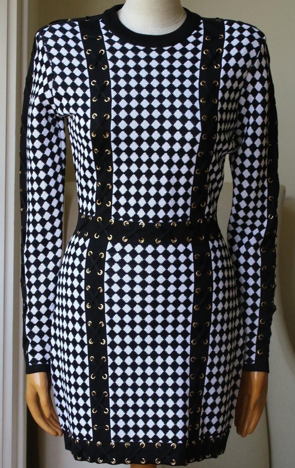 Black and white checked knit dress from Balmain featuring a ribbed round neck, long sleeves, a rear zip fastening, a lace up detail, a fitted silhouette and a short length.

Size: FR 38 (UK 10, US 6, IT 42)

Condition: As new condition, no sign of