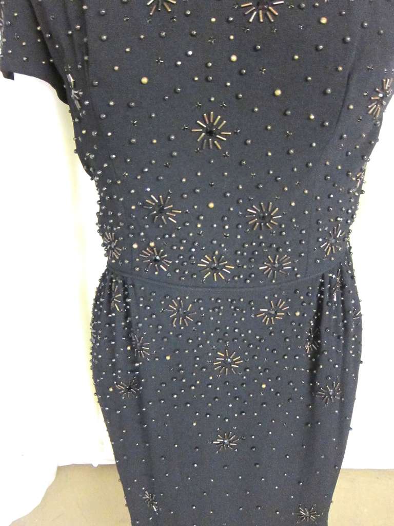 Over the top beading! Jet Black Beads with Bronze metal beads that form starbursts. This is like a dark starry night!  Silky Lining and metal zipper, split in back.  This is a Hollywood Glamor  Girl dress from late 1940s to early 1950s. 

Bust: