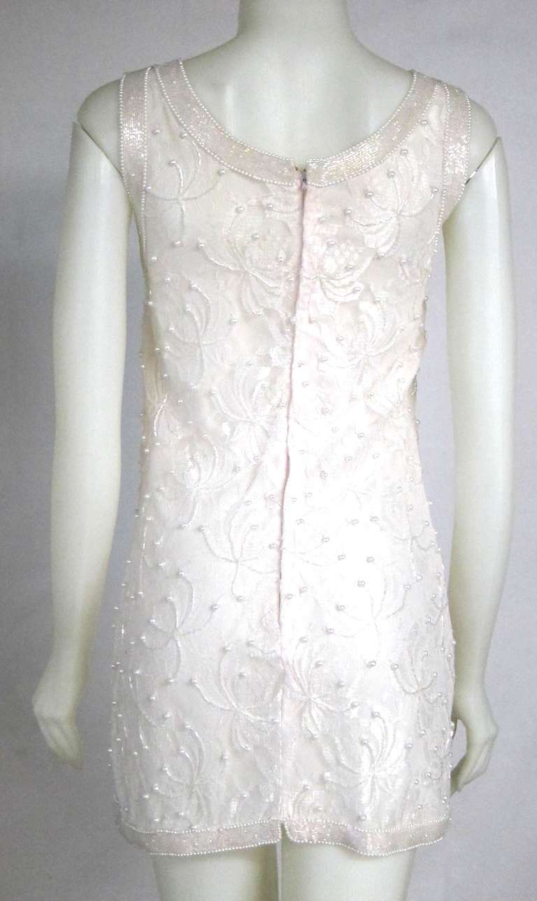 Great dress with matching jacket. They are both heavily beaded with bugle beads and pearls. The lace has a hint of blush.   The dress is sleeveless shift style and the jacket has long sleeves.  Gorgeous set!  Perfect for a summer cocktail party, or