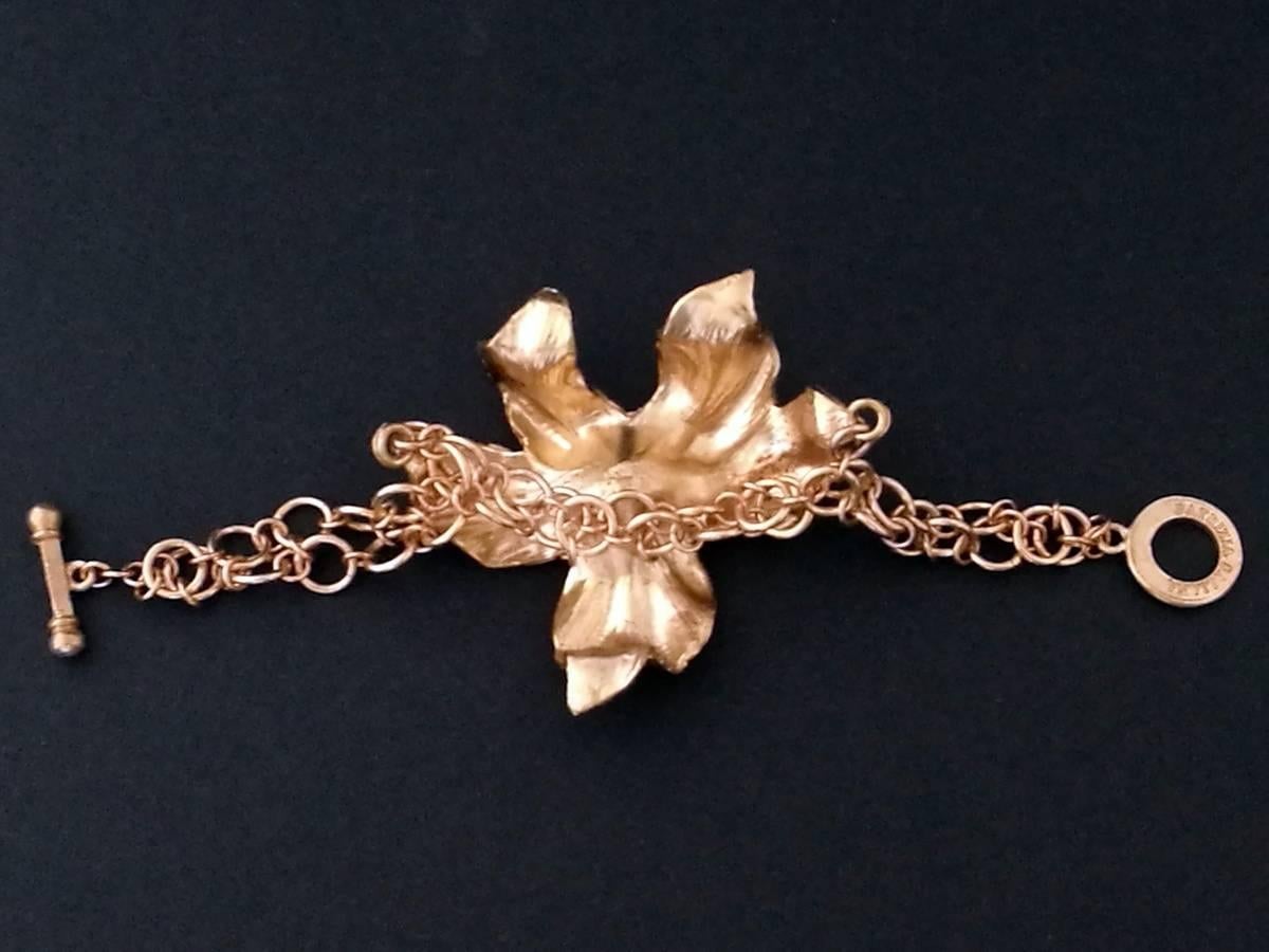Bronze bracelet with hand-finished microfusion orchid, at the center of the flower are placed three oriental mobile pearls. The object was made in Florence by goldsmith craftsmen and designed by Patrizia daliana
