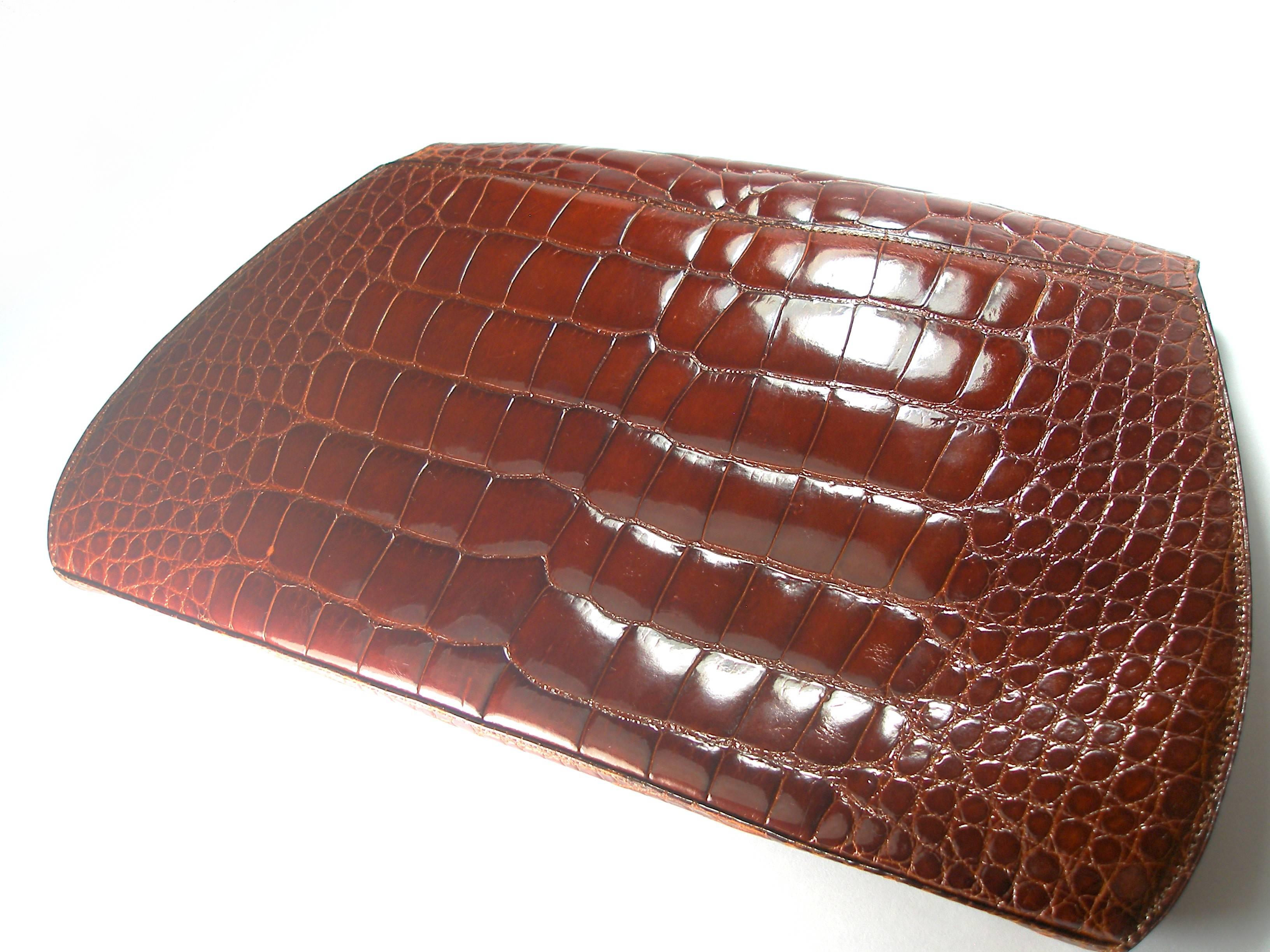Cartier Vintage clutch 
Crocodile leather
Gold plated hadware
A small discoloration under the flap
And between the bellows 
Please look at the picture
Dimensions: 31 x 18 x 4 cm
Year 1990 / Signed Cartier on the clasp
Color: cognac
Delivered without