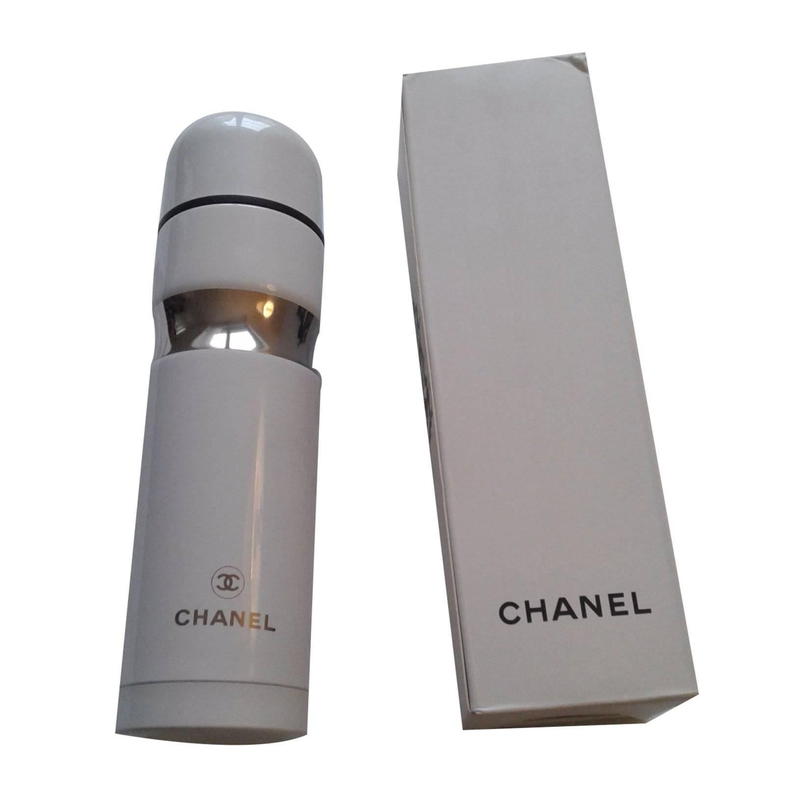 Care for a gold-colored Chanel water bottle with a flask bag for