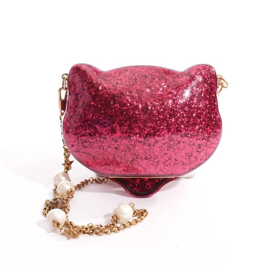 WON-DER-FULL ! SOLD OUT EVERY WHERE 
A glitter plexiglass cat-shaped clutch has an open interior with crystal eyes and a removable chain strap with glass pearls and feline charms.
 Pink glitter plexiglass. 
Glass pearl and feline charms on removable