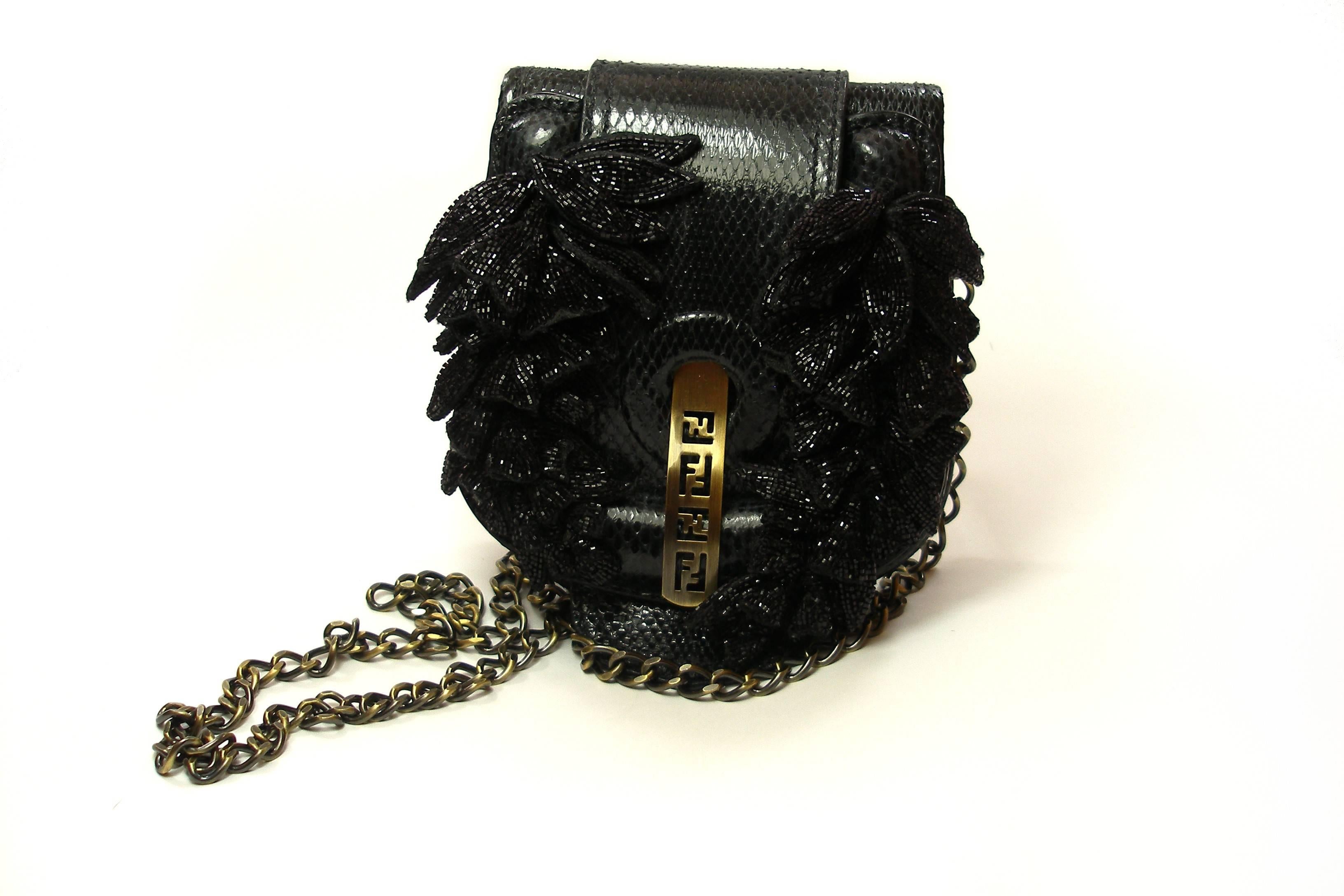 RARE Impossible to find Fendi
Lizard skin and beaded flower
Black color 
PLEASE NOTE THAT ALL BEADS ARE IN TACT this bag was never used and is in excellente condition.
There are two optional chains for carrying the bag, a shorter one that measures