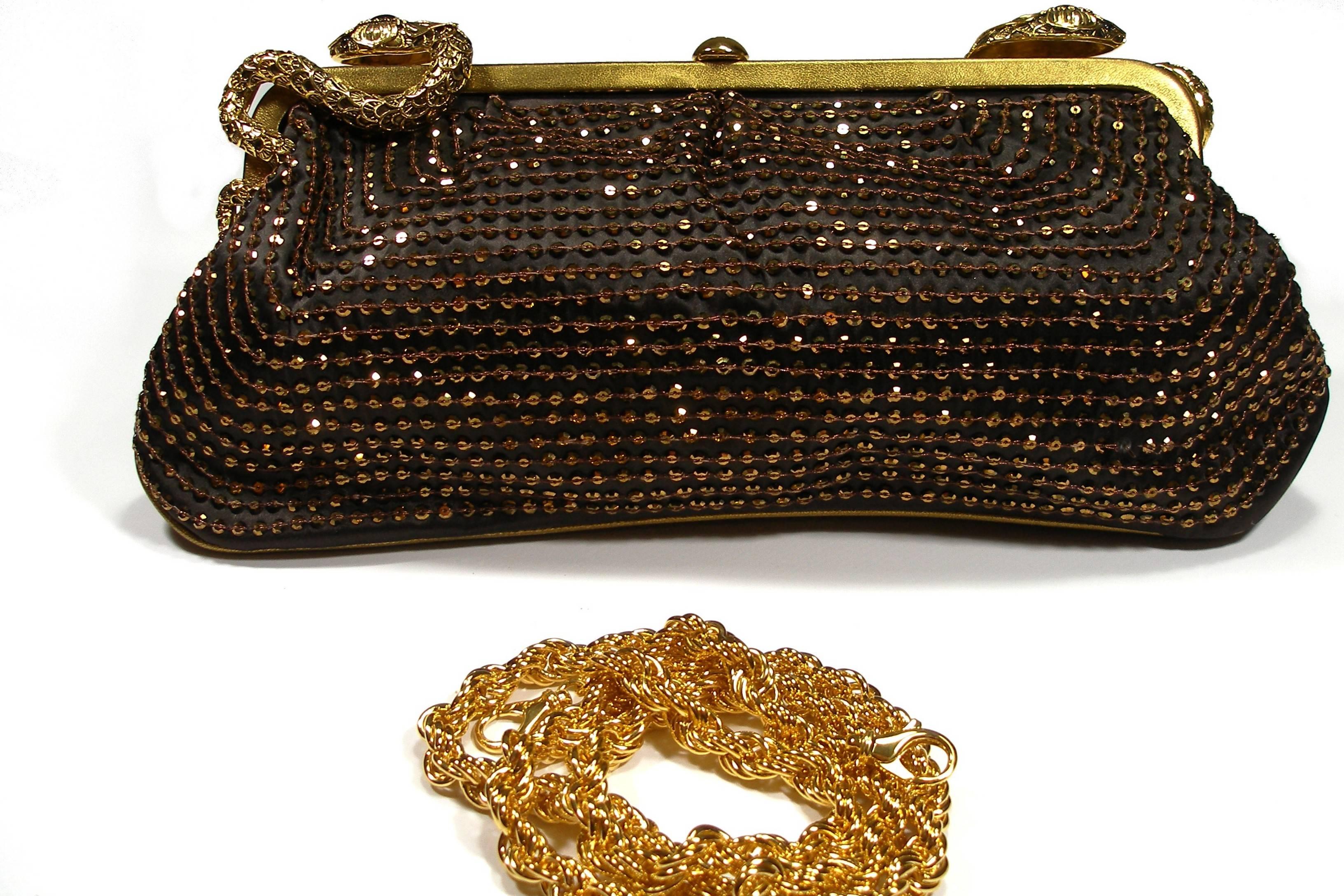 Stunning Roberto Cavalli Sequin Bronze Evening Bag or clutch. Gold python details with rhinestone and bronze sequin . Gold hardware with tan leather interior with a single zip closure. 
Amovible trap in gold métal 
Size : 32 x 15 cm
Strap : 88 cm