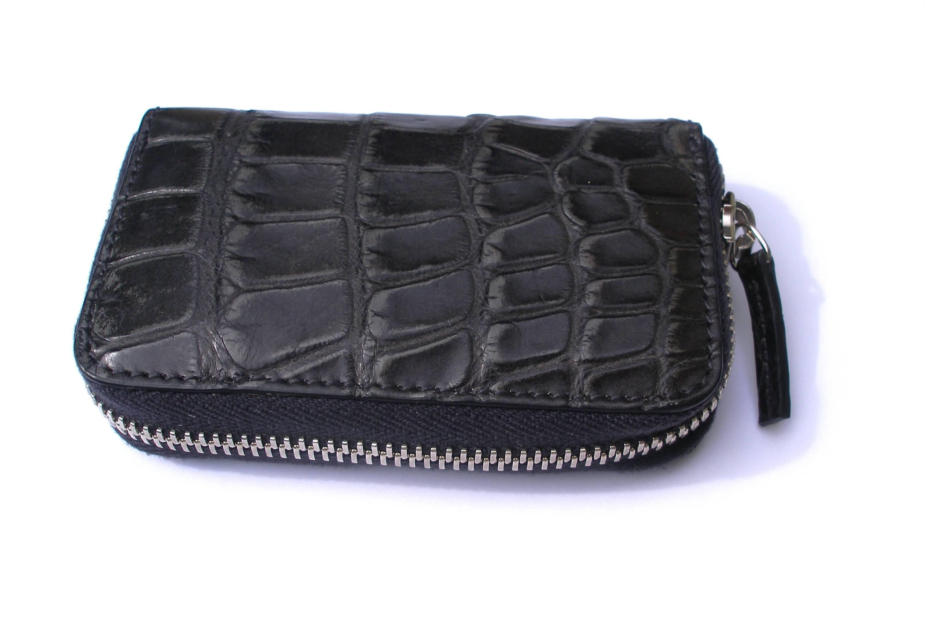     Wonderfull and Good Deal 
    Black Alligator leather with black leather trim/interior
    Palladium toned hardware
    Four card slots and two bill compartments
    Middle zip coin pocket
    Zip around closure
    Small size 
    4.7"L x