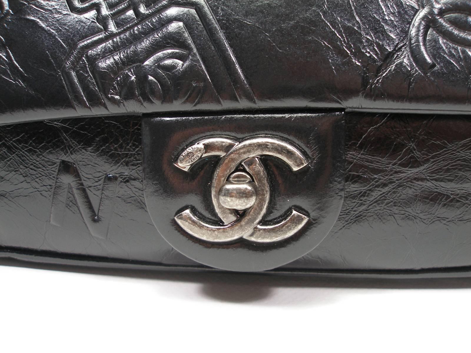 Chanel Precious Symbols Single Flap Bag Embossed Leather 
Antique leather look 
Black color with silver (ruthenium) hardware
Plastic is still on hardware 
Dimensions : 9 