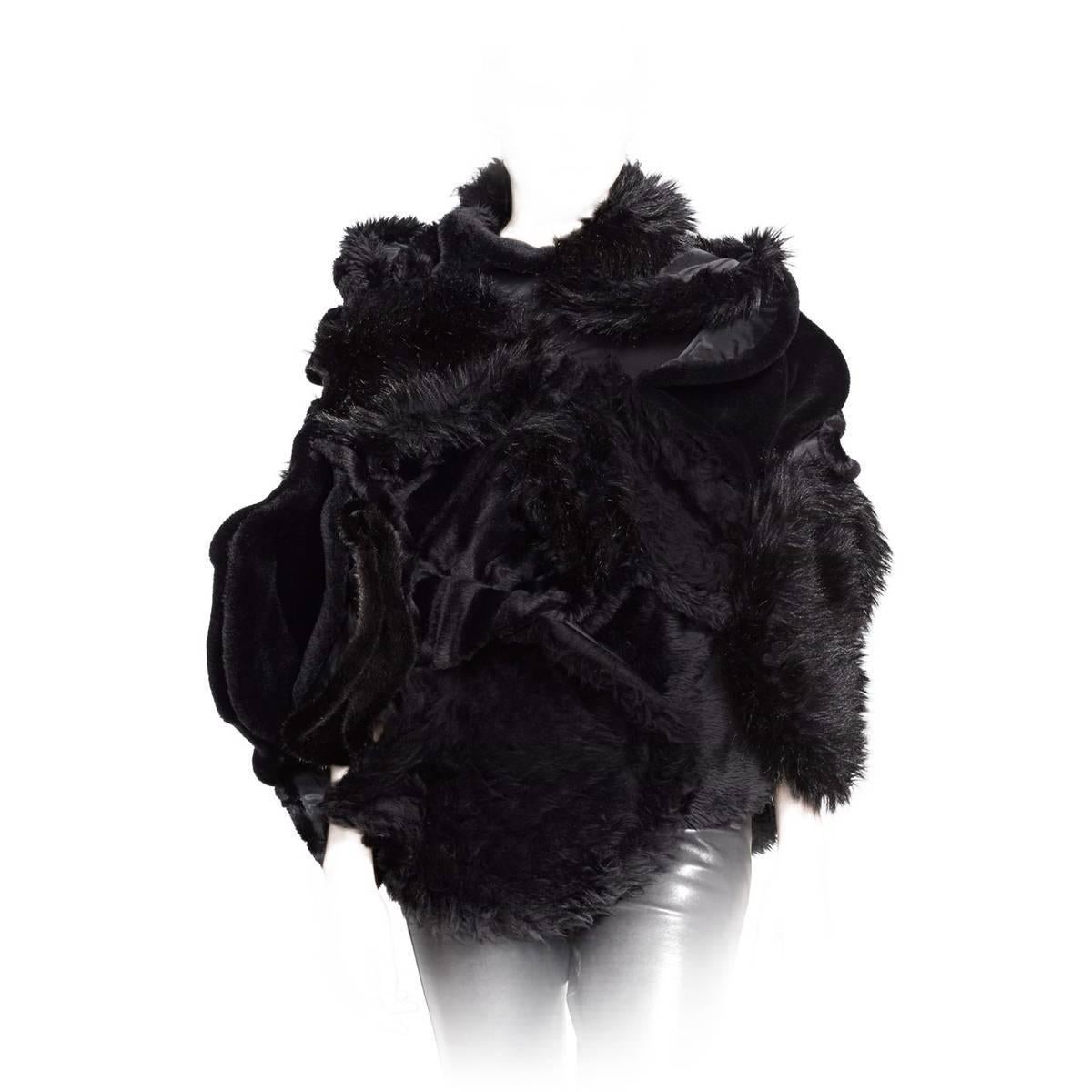 Faux shearling and faux fur add lavish textural dimension to this artfully draped and gathered Junya Watanabe cape jacket.

    29