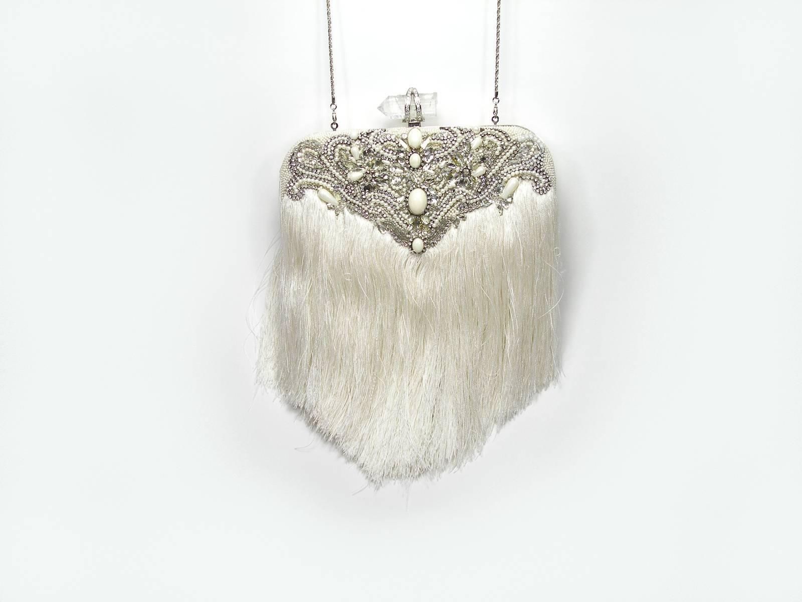Magnificent Piece by Couture Marchesa
Embroidered and embellished with stones
Removable  chain shoulder strap with Fringe
Interior lining with a slip pocket
Frame opening with push-lock closure, embellished with crystal stones 
Size: 25 X 20 X4 cm 