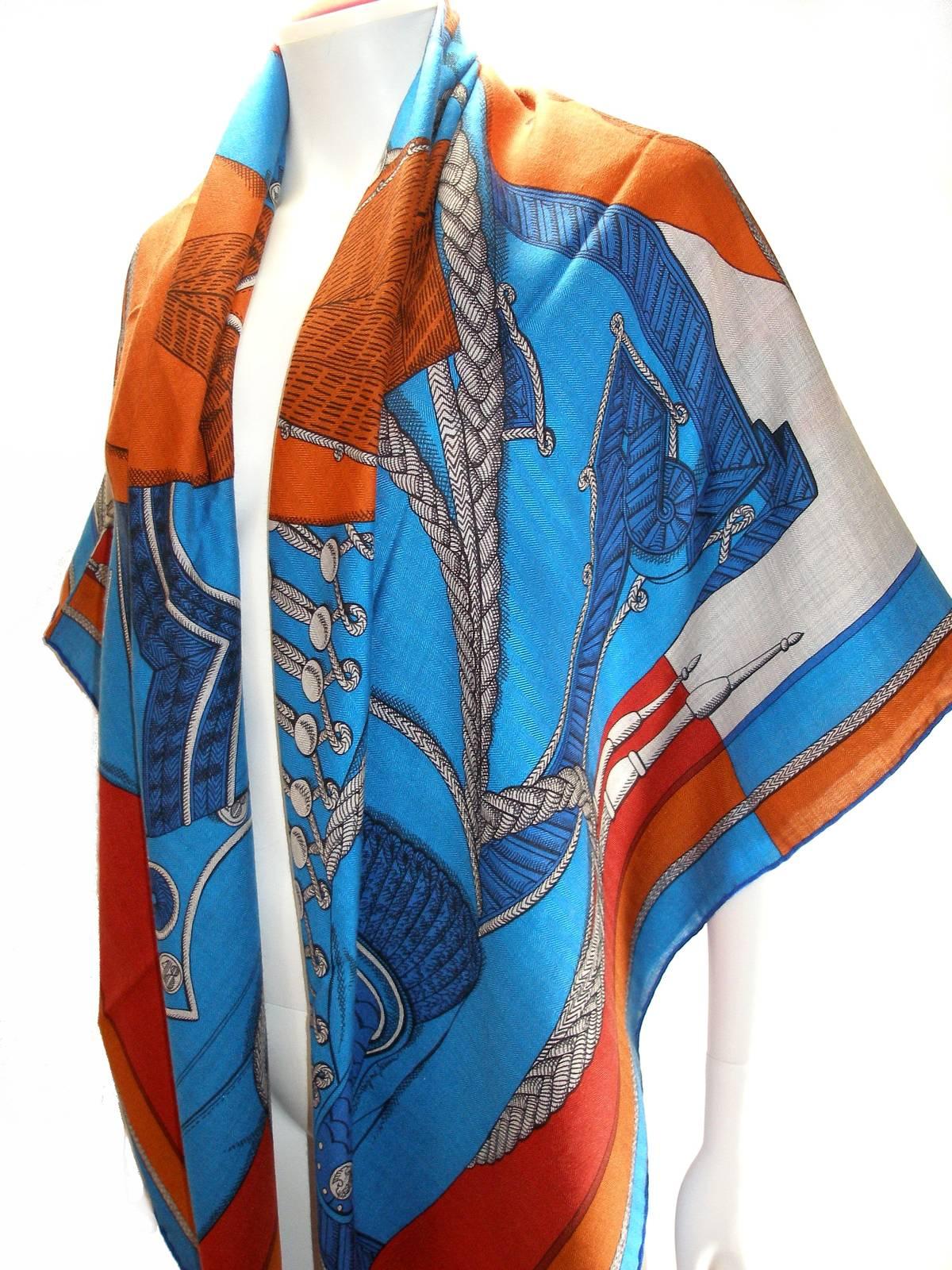 This cashmere has the new composition label of the luxury house Hermès 
Signature  Hermès Paris, © HERMÈS 
Composition :  Châle 70 % cachemire 30 % silk hand sewed and rolled edges 
Care tag is présent
Color :  Bleu / orange
Design by Virginie