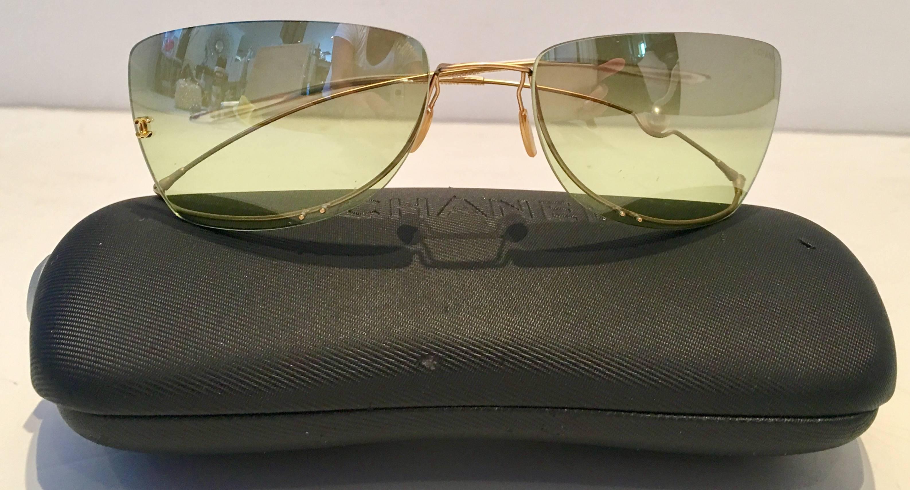 Vintage CHANEL Super lightweight limited edition rimless floating freshwater pearl gold plate wire and green mirrored lens sunglasses, 4053. These collector sunglasses feature a green mirrored lens with gold plate "CC" logo on each lens