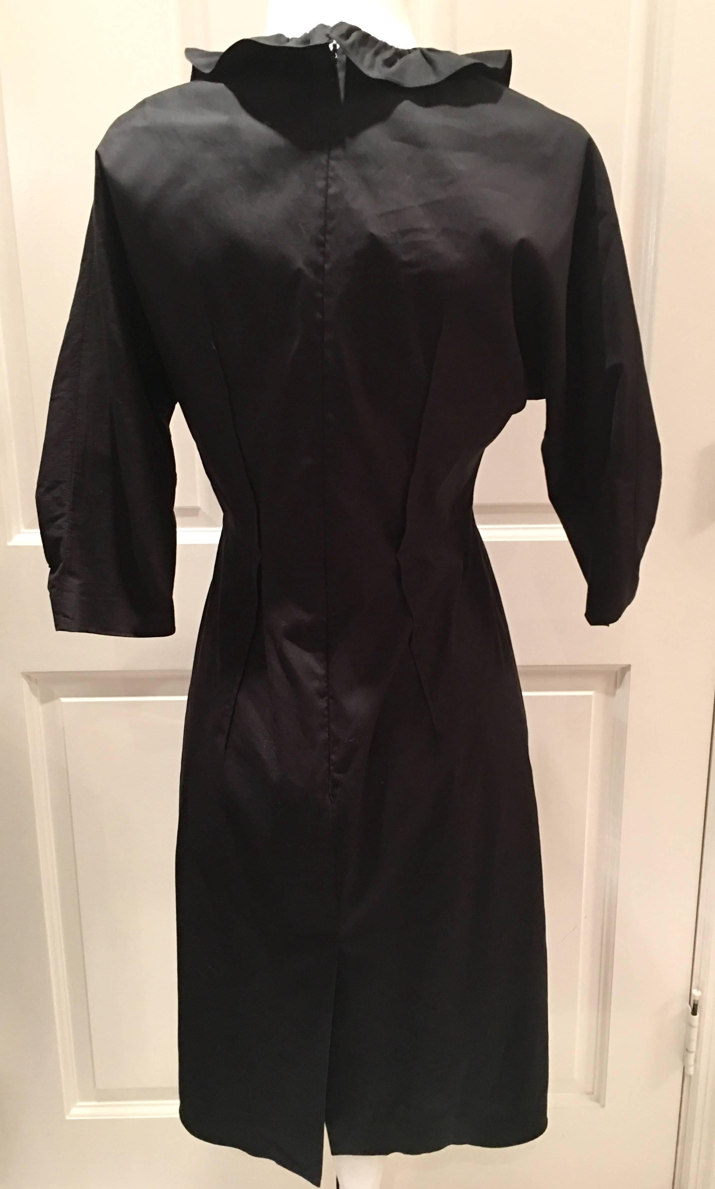 Classic Prada Milano 2010 cotton blend 3/4 inch ruched sleeve knee length dress. Ruffle flap v-neck detail, gathered bodice front and back for best fit with elastane content for variable fit. Back zipper and hook closure with a 10" inch back